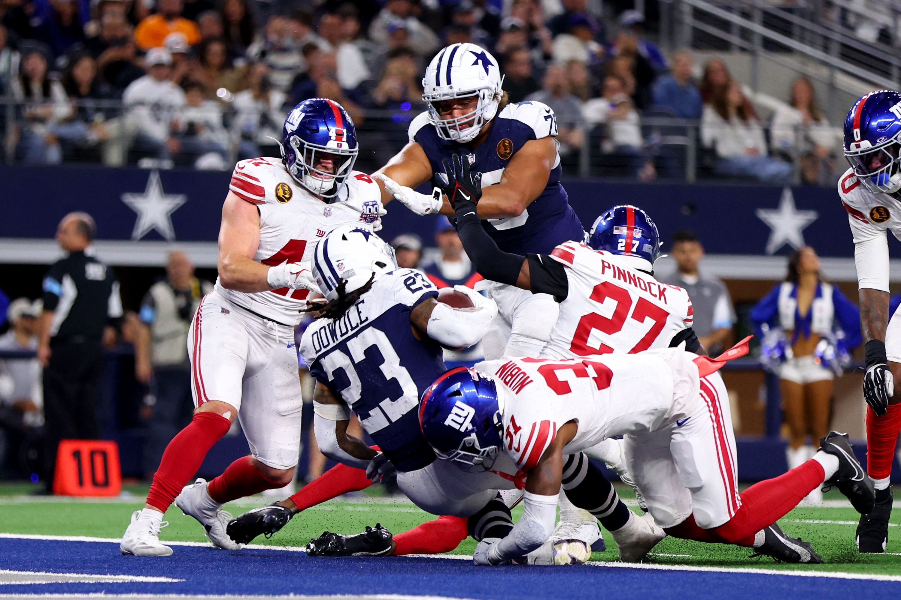 ARLINGTON, TEXAS - NOVEMBER 28: Rico Dowdle #23 of the Dallas Cowboys scores a touchdown during the third quarter against the New York Giants at AT&T Stadium on November 28, 2024 in Arlington, Texas.   Sam Hodde/Getty Images/AFP (Photo by Sam Hodde / GETTY IMAGES NORTH AMERICA / Getty Images via AFP)