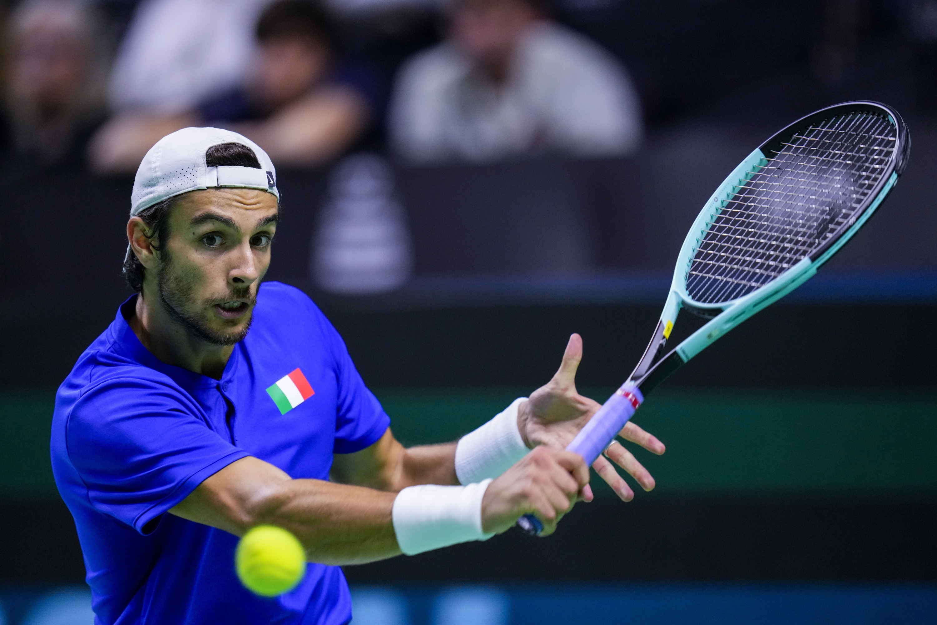 Italy's Lorenzo Musetti returns the ball to Argentina's Francisco Cerundolo during a Davis Cup quarterfinal match at the Martin Carpena Sports Hall in Malaga, southern Spain, on Thursday, Nov. 21, 2024. (AP Photo/Manu Fernandez)