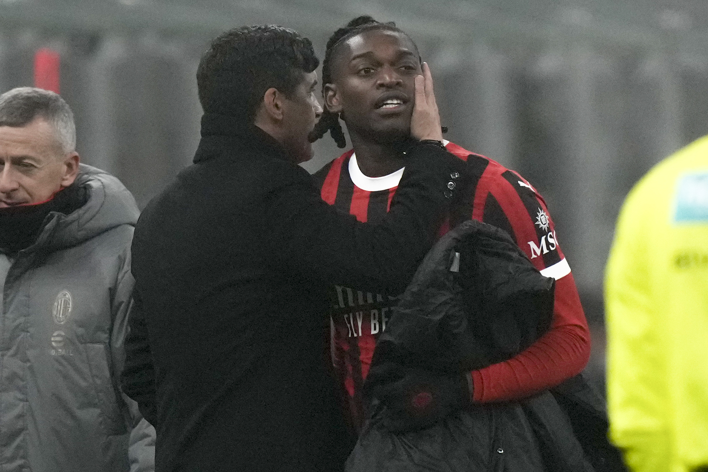 AC Milan's head coach Paulo Fonseca talks to forward Rafael Leao during the Italian Serie A soccer match between AC Milan and Empoli, at the Milan San Siro stadium, Italy, Saturday, Nov. 30, 2024. (AP Photo/Luca Bruno)