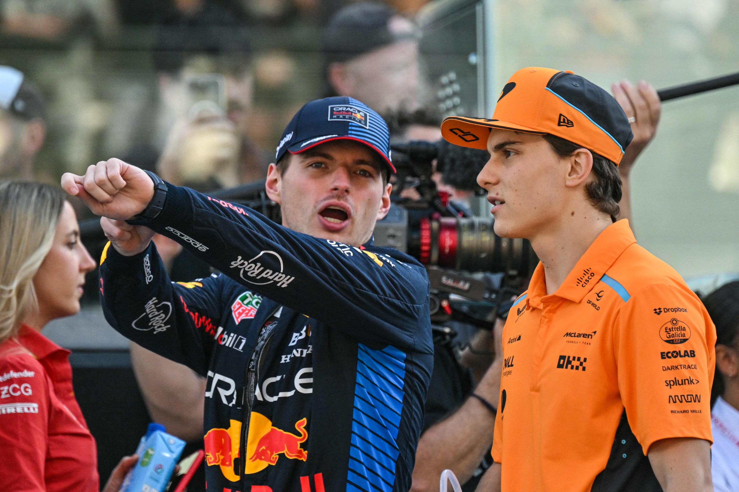 Red Bull Racing's Dutch driver Max Verstappen (L) and McLaren's Australian driver Oscar Piastri arrive ahead of the Abu Dhabi Formula One Grand Prix at the Yas Marina Circuit in Abu Dhabi on December 8, 2024. (Photo by Andrej ISAKOVIC / AFP)