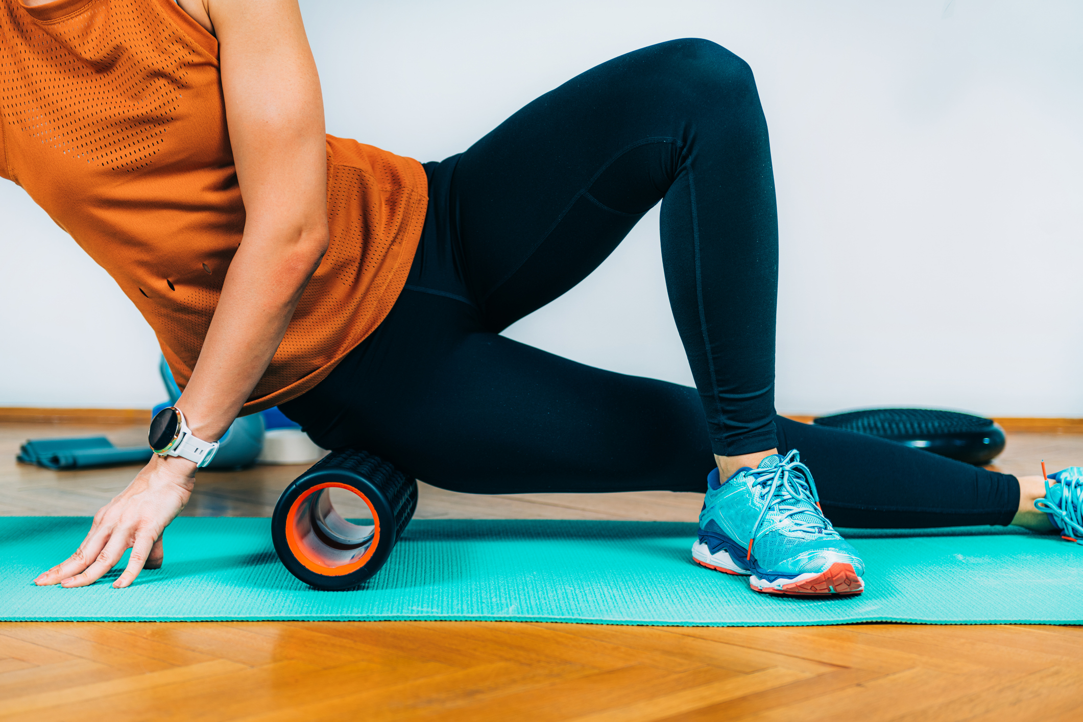 Woman Using Foam Roller Massager at Home.