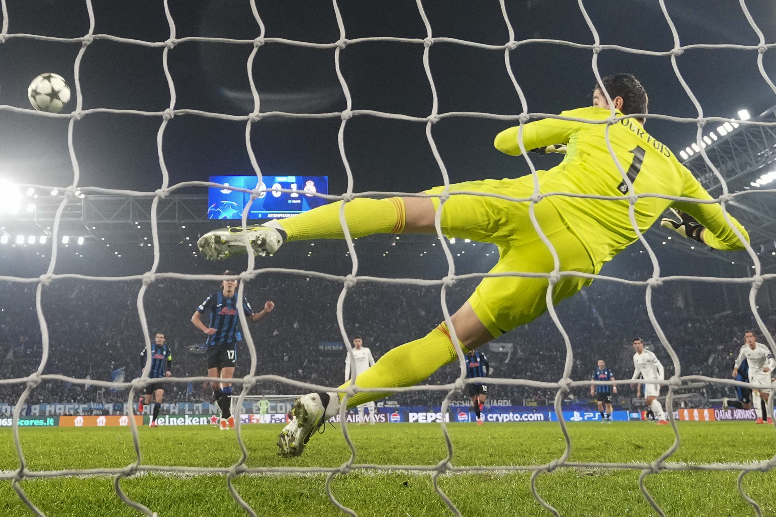 Atalanta's Charles De Ketelaere scores his side's first goal on a penalty kick past Real Madrid's goalkeeper Thibaut Courtois during the Champions League opening phase soccer match between Atalanta and Real Madrid at the Bergamo's stadium, in Bergamo, Italy, Tuesday, Dec. 10, 2024. (AP Photo/Antonio Calanni)