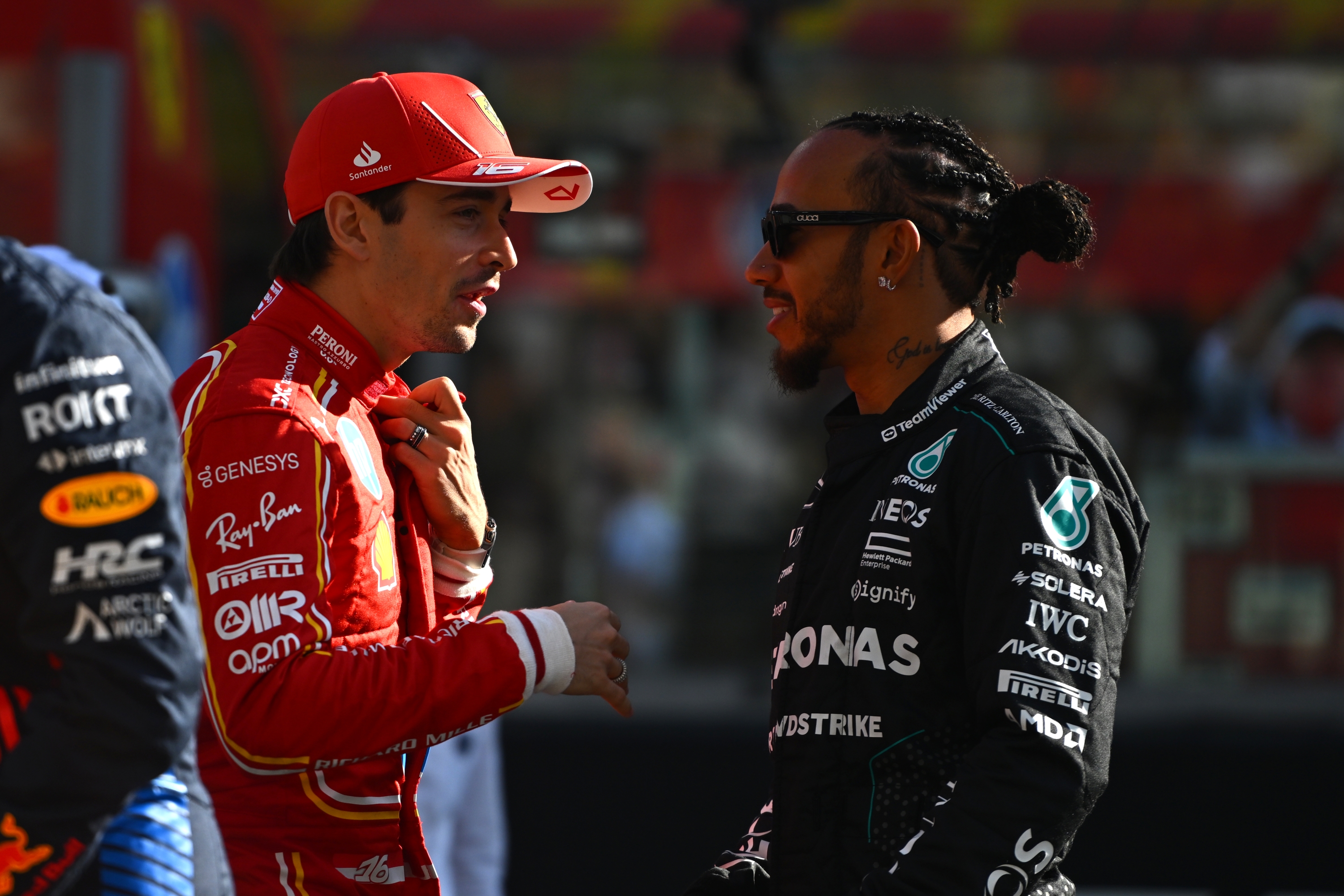 ABU DHABI, UNITED ARAB EMIRATES - DECEMBER 08: Charles Leclerc of Monaco and Ferrari and Lewis Hamilton of Great Britain and Mercedes talk prior to the F1 Grand Prix of Abu Dhabi at Yas Marina Circuit on December 08, 2024 in Abu Dhabi, United Arab Emirates. (Photo by Rudy Carezzevoli/Getty Images)