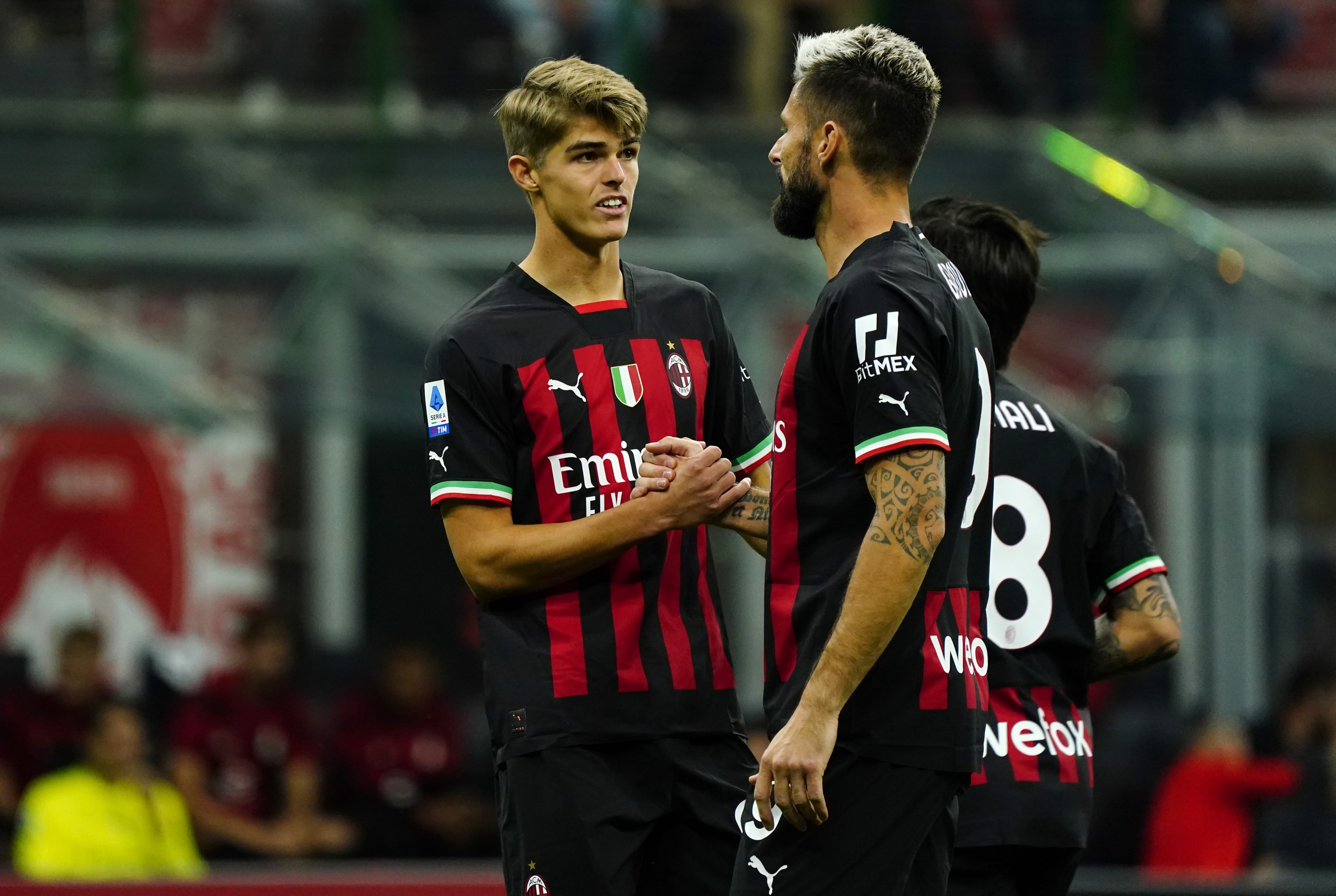 MILAN, ITALY - SEPTEMBER 18: Charles De Ketelaere and Olivier Giroud of AC Milan cheers during the Serie A match between AC MIlan and SSC Napoli at Stadio Giuseppe Meazza on September 18, 2022 in Milan, Italy. (Photo by Pier Marco Tacca/AC Milan via Getty Images)