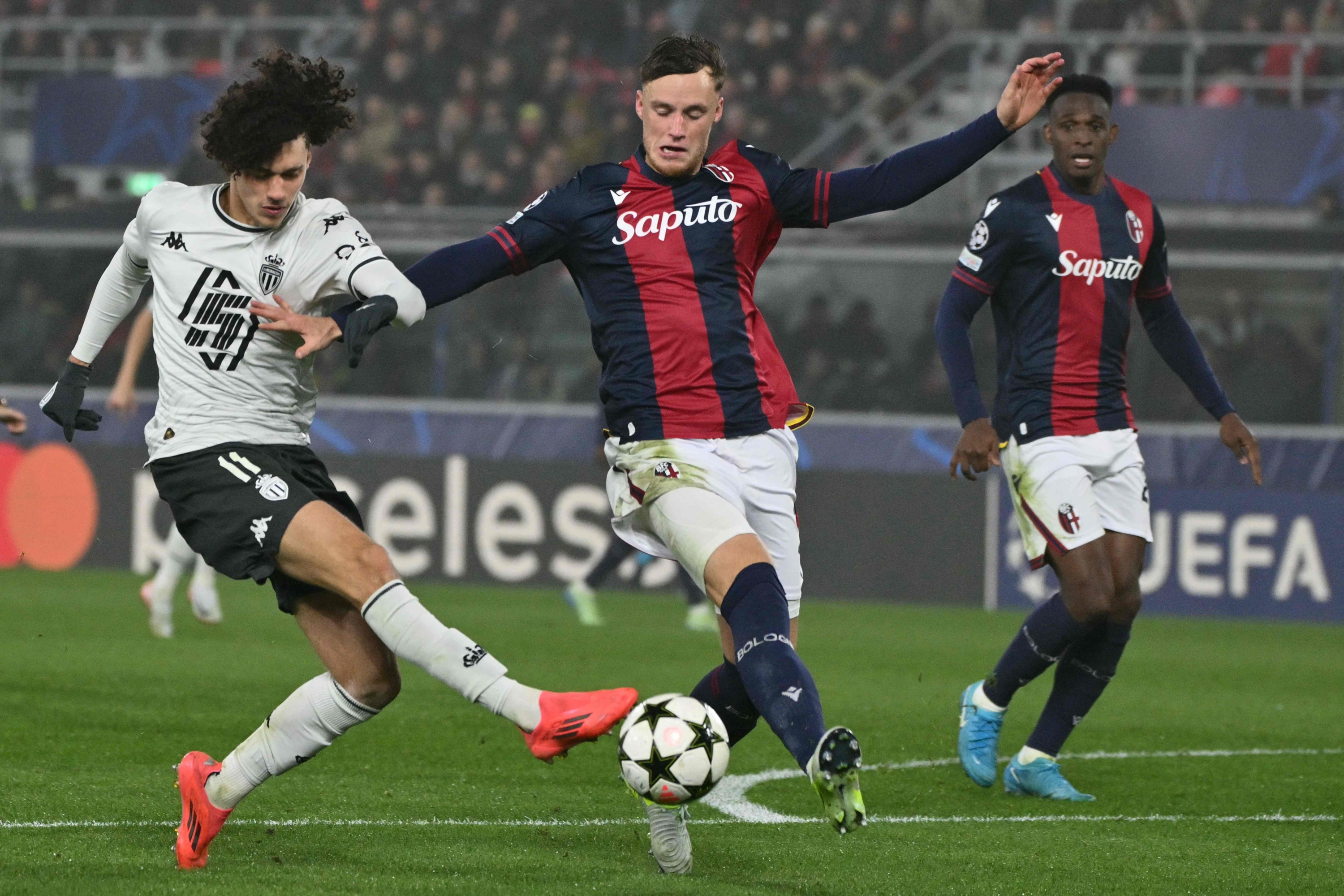 Monaco's French midfielder #11 Maghnes Akliouche kicks the ball in front of Bologna's Dutch defender #31 Sam Beukema during the Champions League football match between Bologna FC and AS Monaco at the Renato Dall'Ara stadium in Bologna on  November 5, 2024. (Photo by Alberto PIZZOLI / AFP)