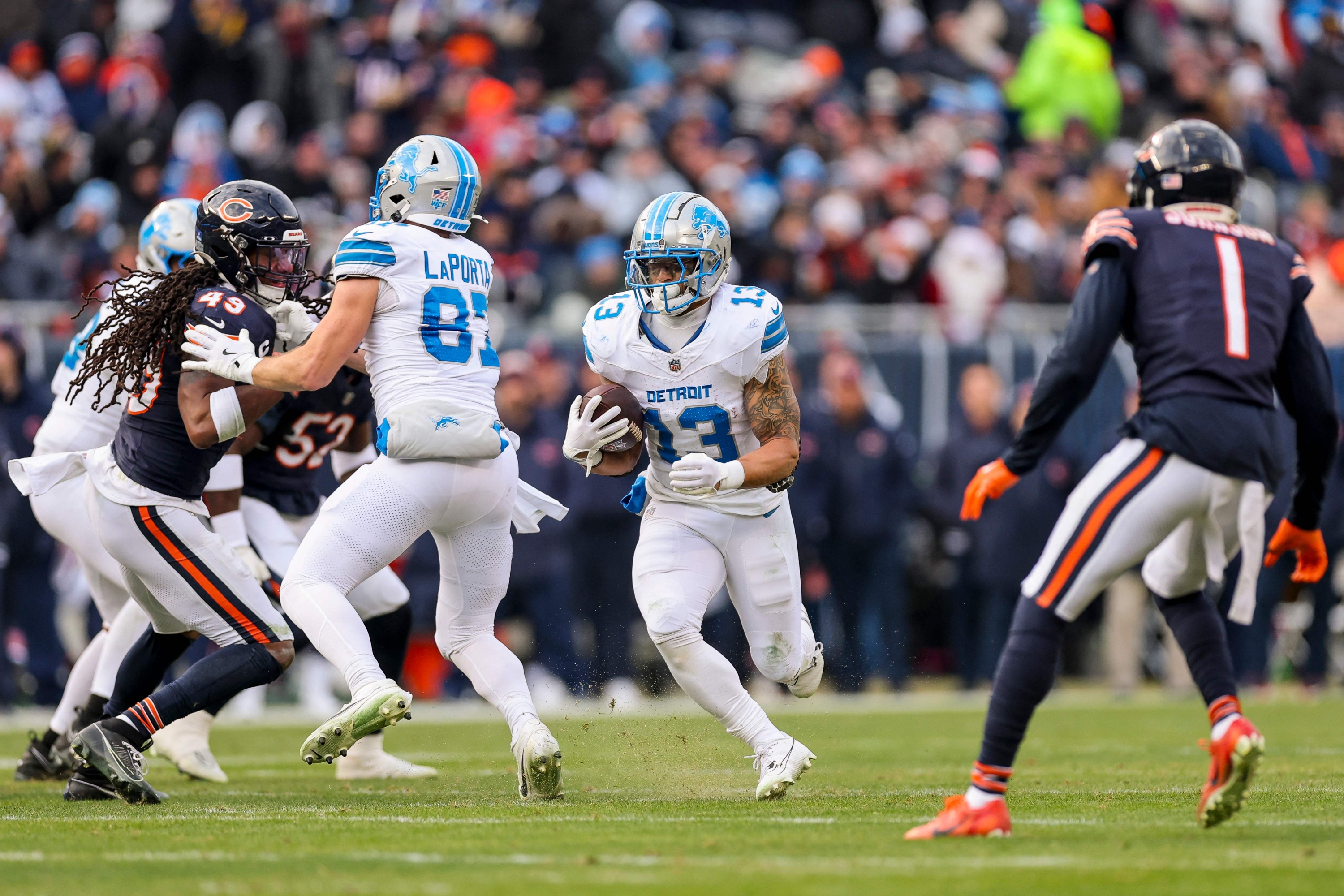 CHICAGO, ILLINOIS - DECEMBER 22: Craig Reynolds #13 of the Detroit Lions carries the ball against the Chicago Bears during the third quarter at Soldier Field on December 22, 2024 in Chicago, Illinois.   Michael Reaves/Getty Images/AFP (Photo by Michael Reaves / GETTY IMAGES NORTH AMERICA / Getty Images via AFP)