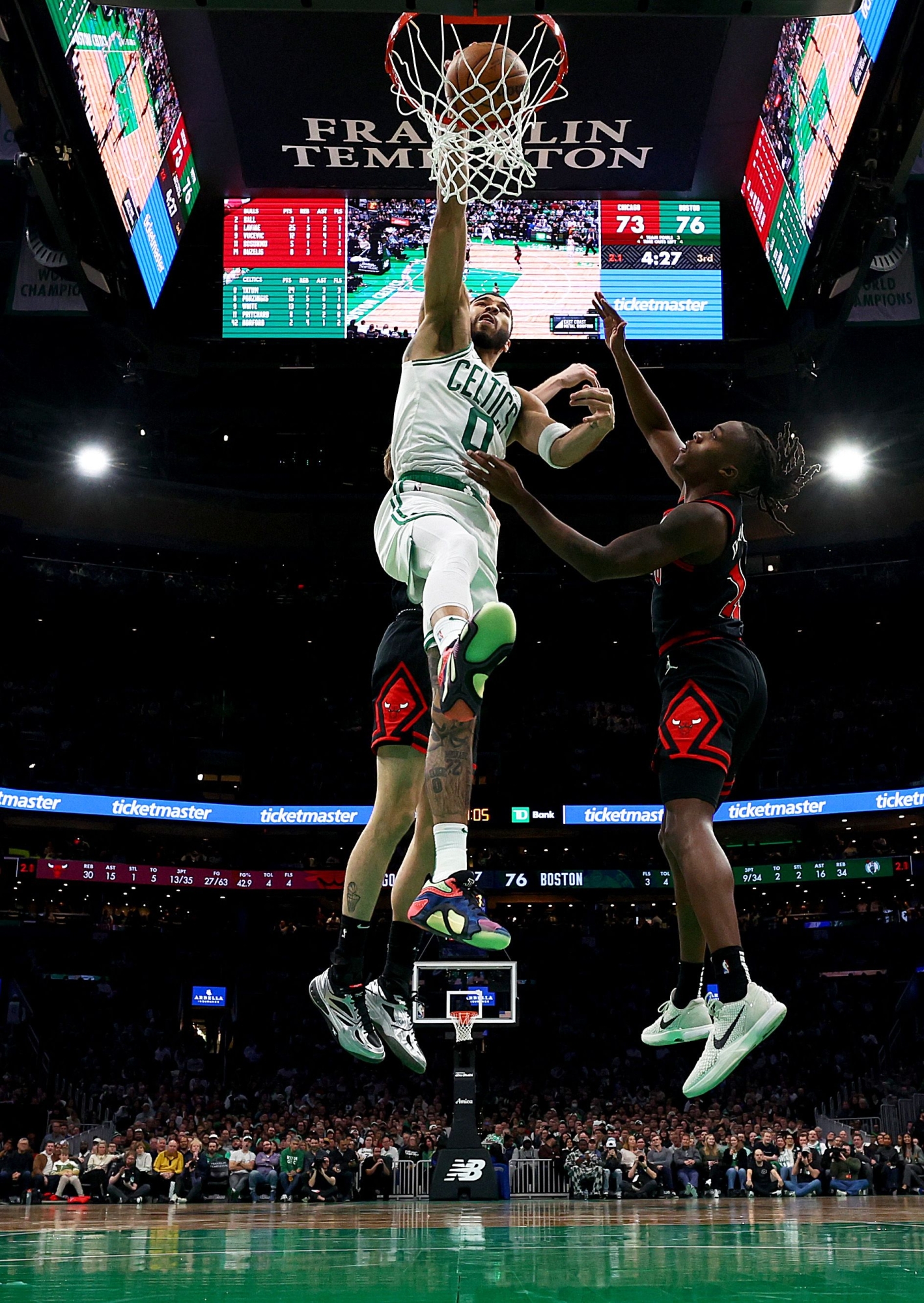 BOSTON, MASSACHUSETTS - DECEMBER 19: Jayson Tatum #0 of the Boston Celtics dunks the ball over Ayo Dosunmu #11 of the Chicago Bulls at TD Garden on December 19, 2024 in Boston, Massachusetts. The Bulls defeat the Celtics 117-108.   Maddie Meyer/Getty Images/AFP (Photo by Maddie Meyer / GETTY IMAGES NORTH AMERICA / Getty Images via AFP)