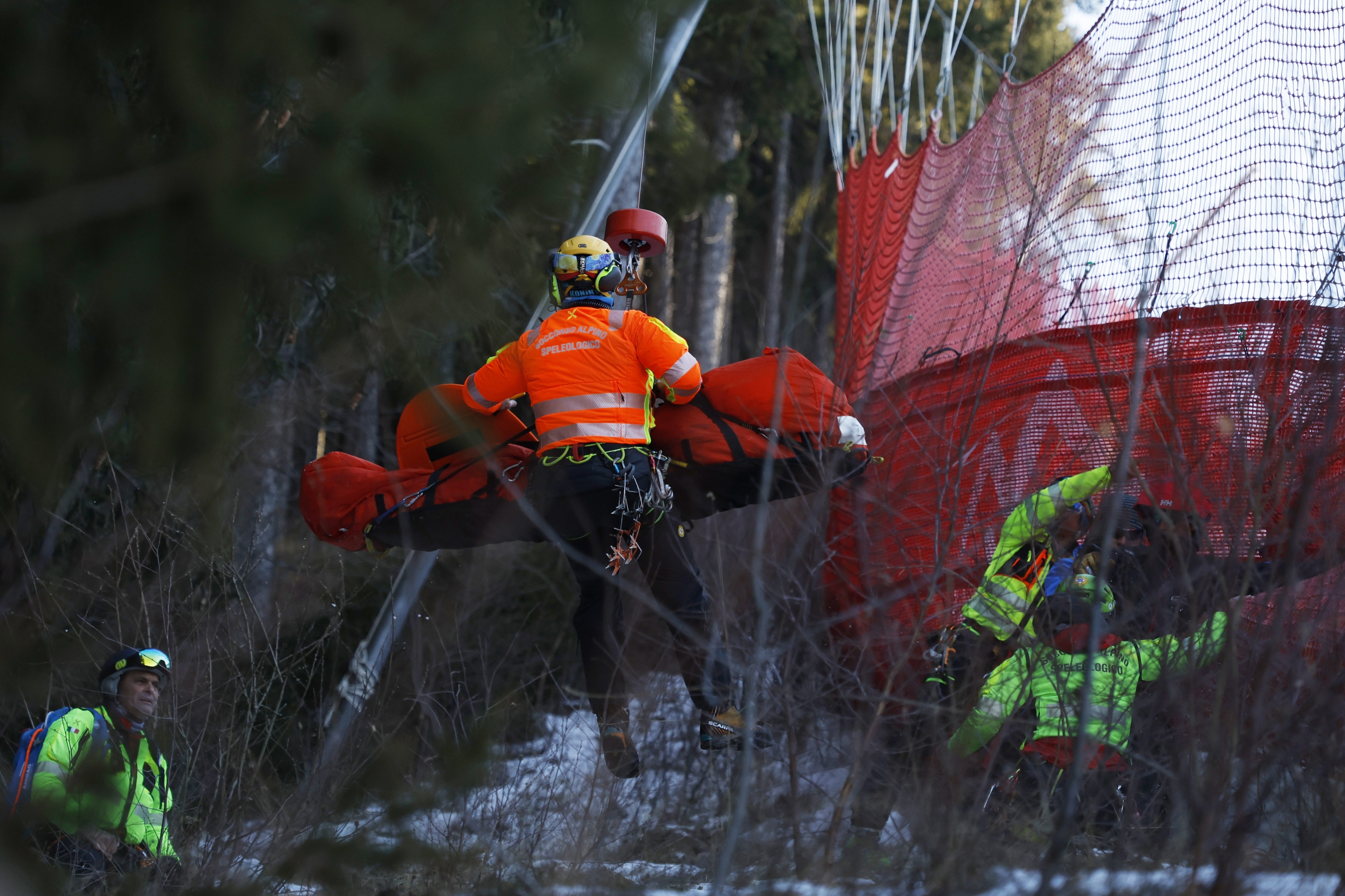 Medical staff are carrying France's Cyprien Sarrazin after crashing into protections net during an alpine ski, men's World Cup downhill training, in Bormio, Italy, Friday, Dec. 27, 2024. (AP Photo/Alessandro Trovati)