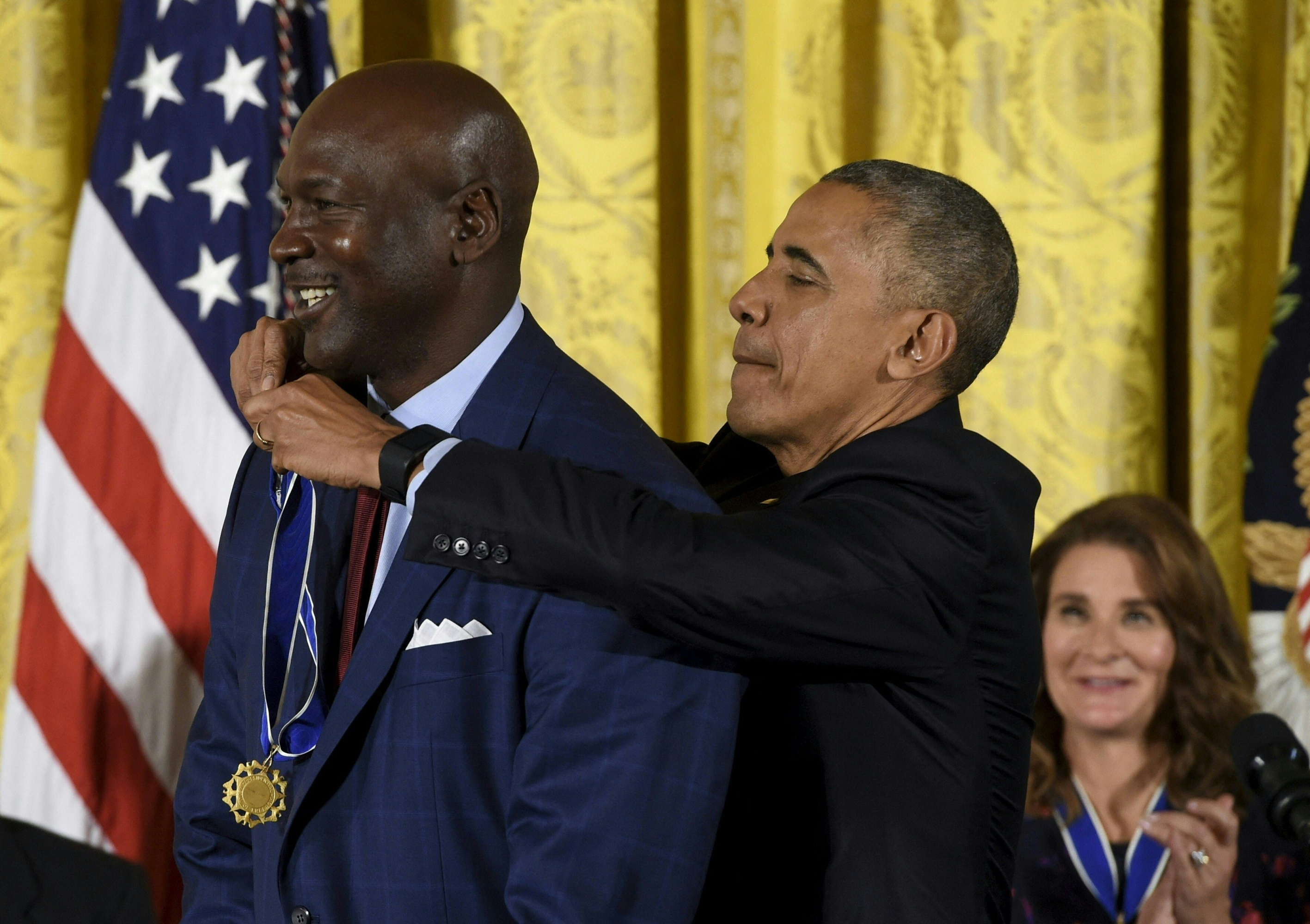 US President Barack Obama presents NBA star and athlete Michael Jordan with the Presidential Medal of Freedom, the nation's highest civilian honor, during a ceremony honoring 21 recipients, in the East Room of the White House in Washington, DC, November 22, 2016. (Photo by SAUL LOEB / AFP)