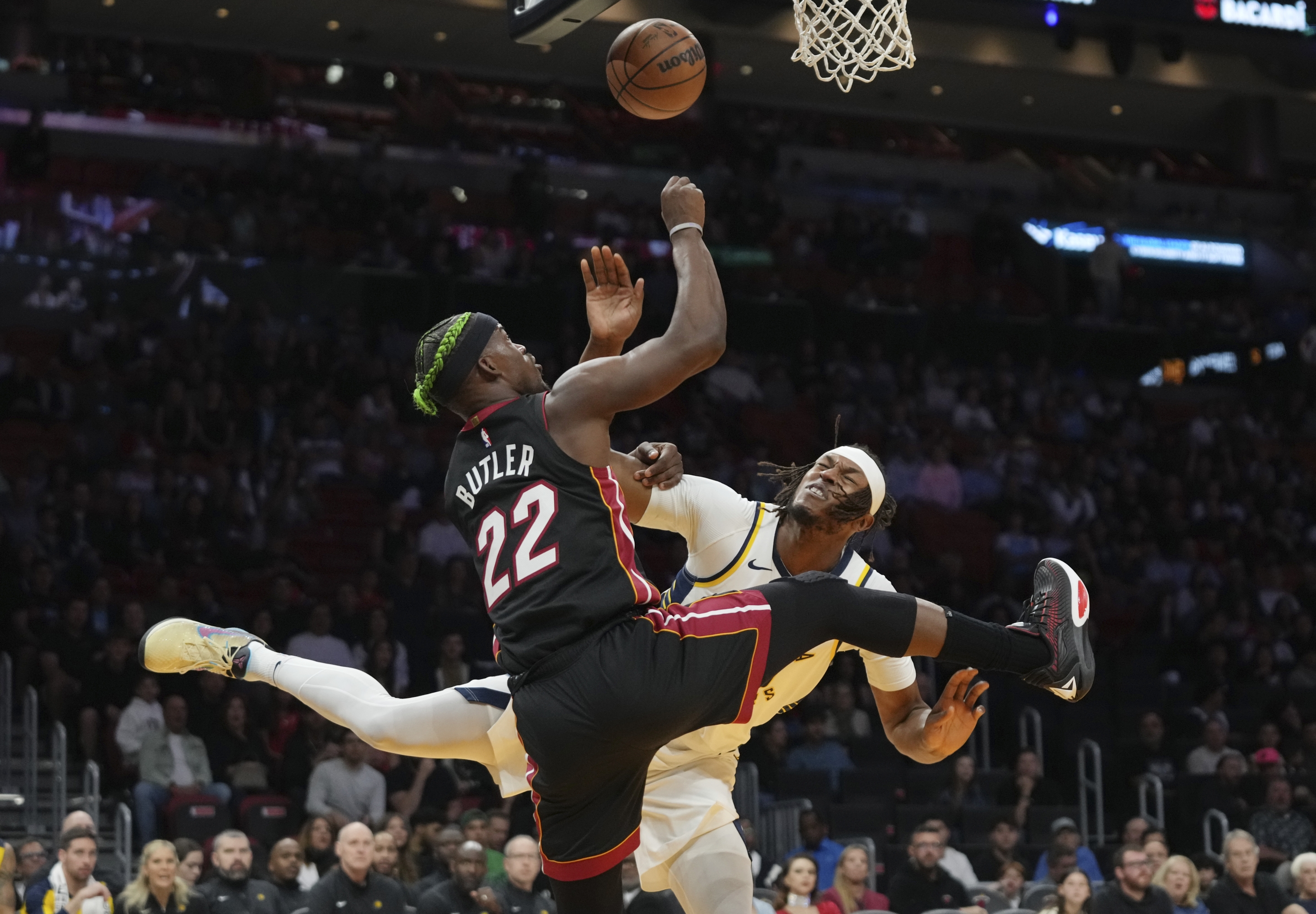 Miami Heat forward Jimmy Butler (22) goes to the basket as Indiana Pacers center Myles Turner, right, defends during the first half of an NBA basketball game Thursday, Jan. 2, 2025, in Miami. (AP Photo/Lynne Sladky)