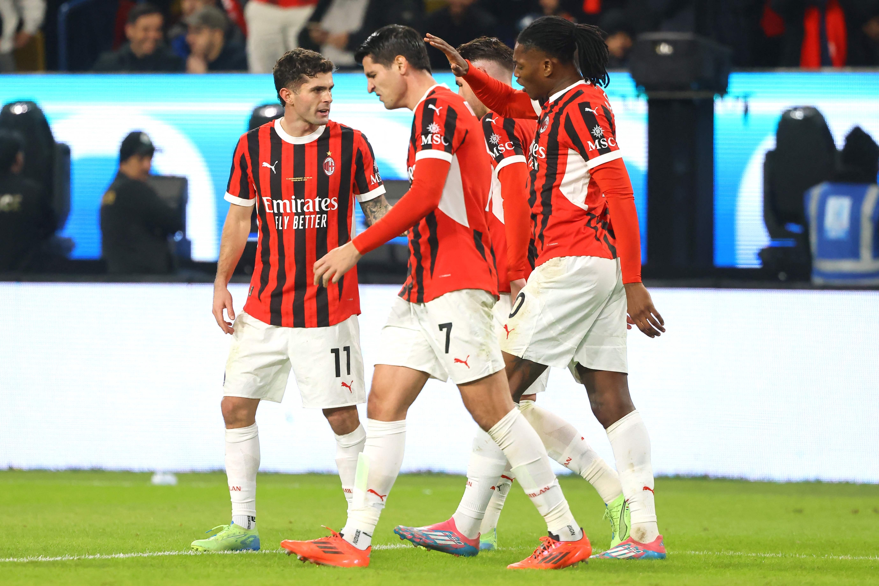 AC Milan's US forward #11 Christian Pulisic celebrates with teammates after scoring their second goal during the Italian Super Cup final football match between Inter Milan and AC Milan at the Al-Awwal Park in Riyadh on January 6, 2025. (Photo by Fayez NURELDINE / AFP)