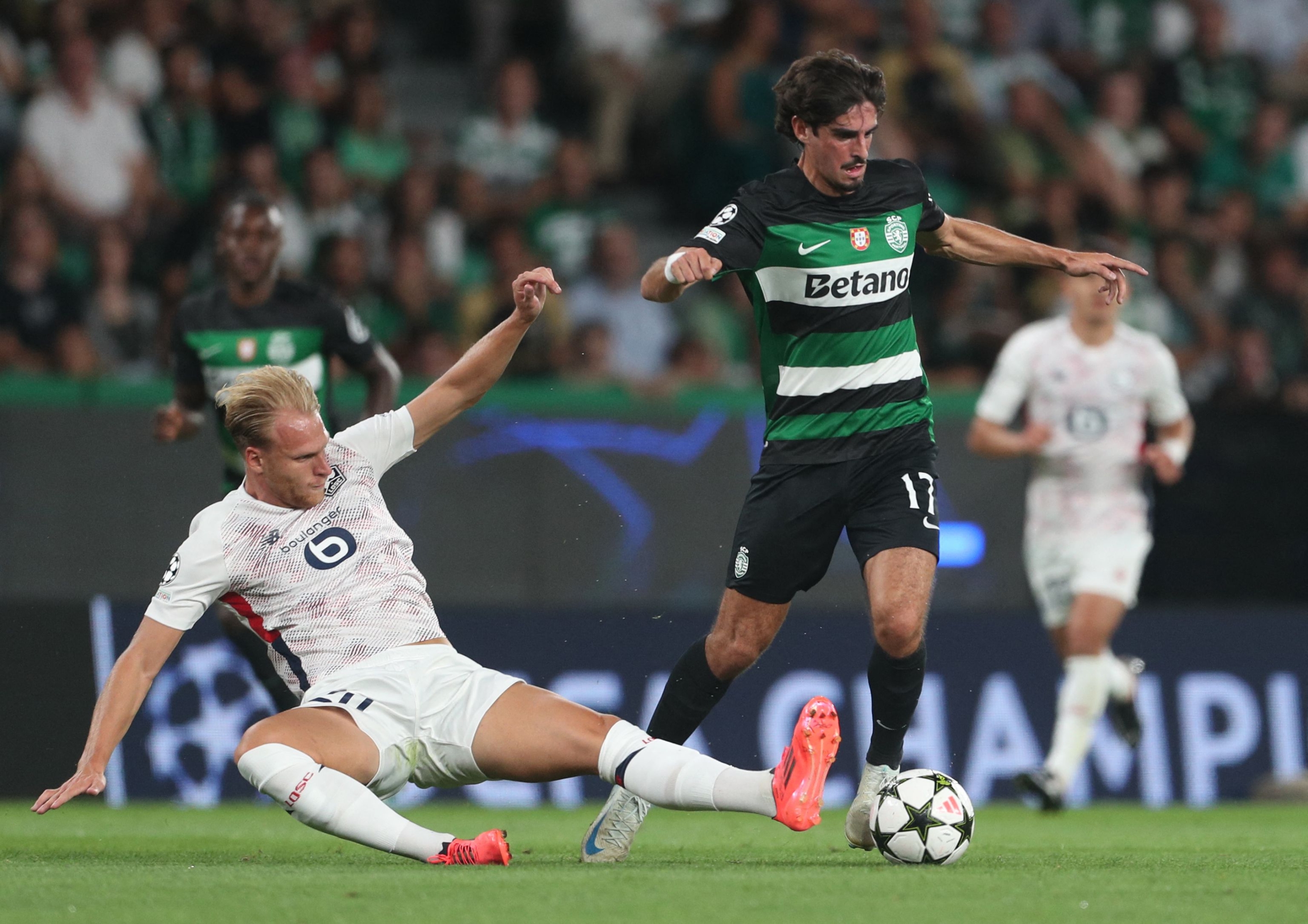 Sporting Lisbon's Portuguese forward #17 Francisco Trincao fights for the ball with Lille's Dutch defender #20 Mitchel Bakker during the UEFA Champions League 1st round day 1 football match between Sporting CP and LOSC Lille, at Alvalade stadium in Lisbon, on September 17, 2024. (Photo by CARLOS COSTA / AFP)