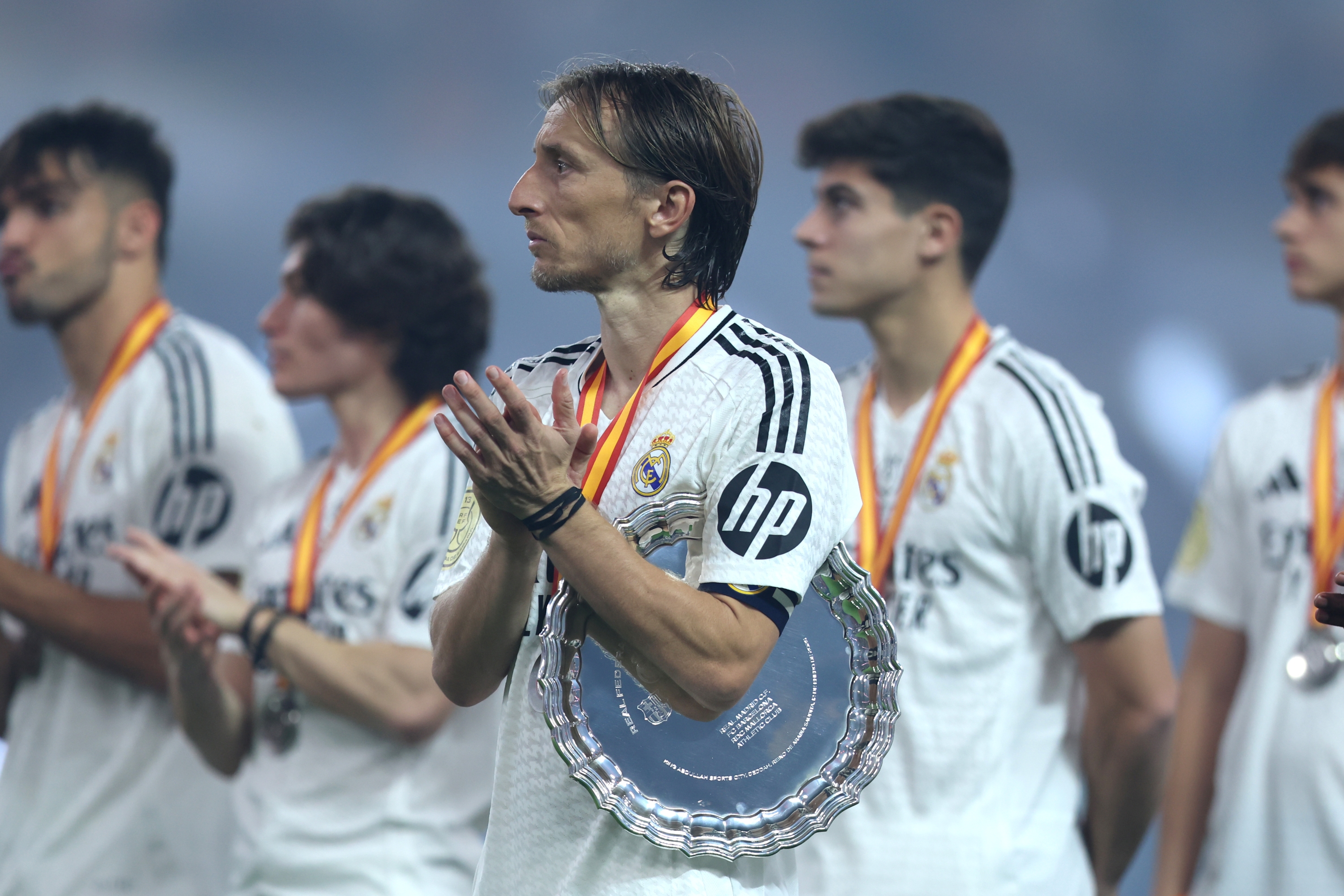 JEDDAH, SAUDI ARABIA - JANUARY 12: Luka Modric of Real Madrid applauds while holding the Supercopa de Espana runners up shield during the trophy presentation after the Spanish Super Cup Final between Real Madrid and FC Barcelona at King Abdullah Sports City on January 12, 2025 in Jeddah, Saudi Arabia. (Photo by Yasser Bakhsh/Getty Images)