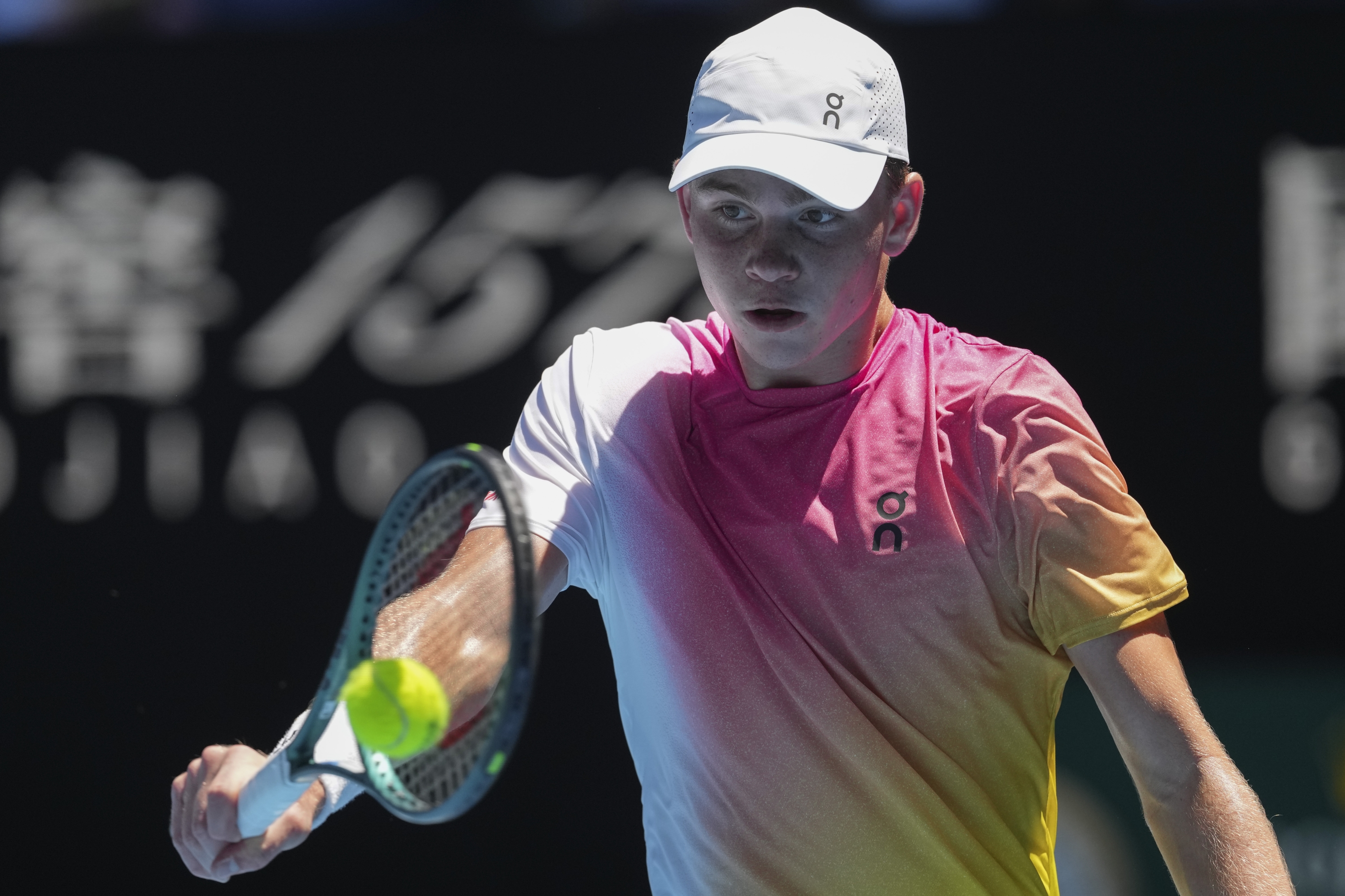 Henry Bernet of Switzerland plays a backhand return to Benjamin Willwerth of the U.S. during the boy's singles final at the Australian Open tennis championship in Melbourne, Australia, Saturday, Jan. 25, 2025. (AP Photo/Mark Baker)