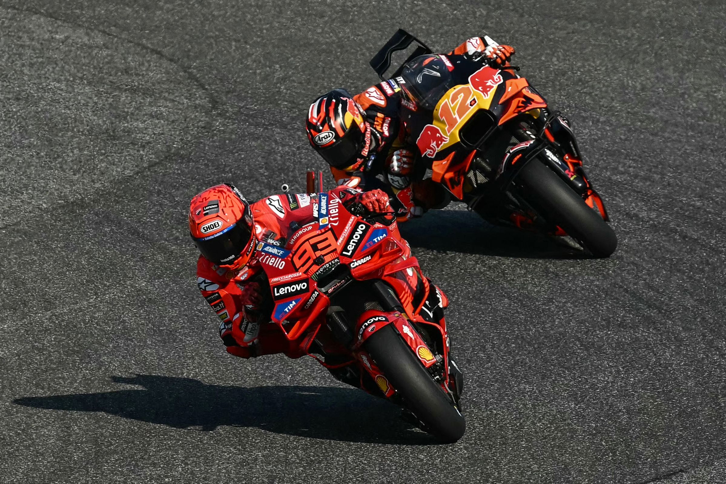 Ducati Lenovo's Spanish rider Marc Marquez rides in front of Red Bull KTM Tech3's Spanish rider Maverick Vinales (back) during the practice session of the MotoGP Thailand Grand Prix at the Buriram International Circuit in Buriram on February 28, 2025. (Photo by MOHD RASFAN / AFP)