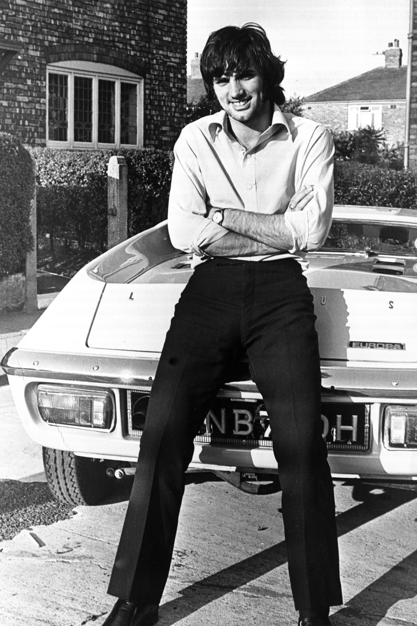 Footballer George Best seen here outside his Manchester home leaning against his new car, a Lotus Europa. 17th October 1969. (Photo by Mirrorpix via Getty Images)