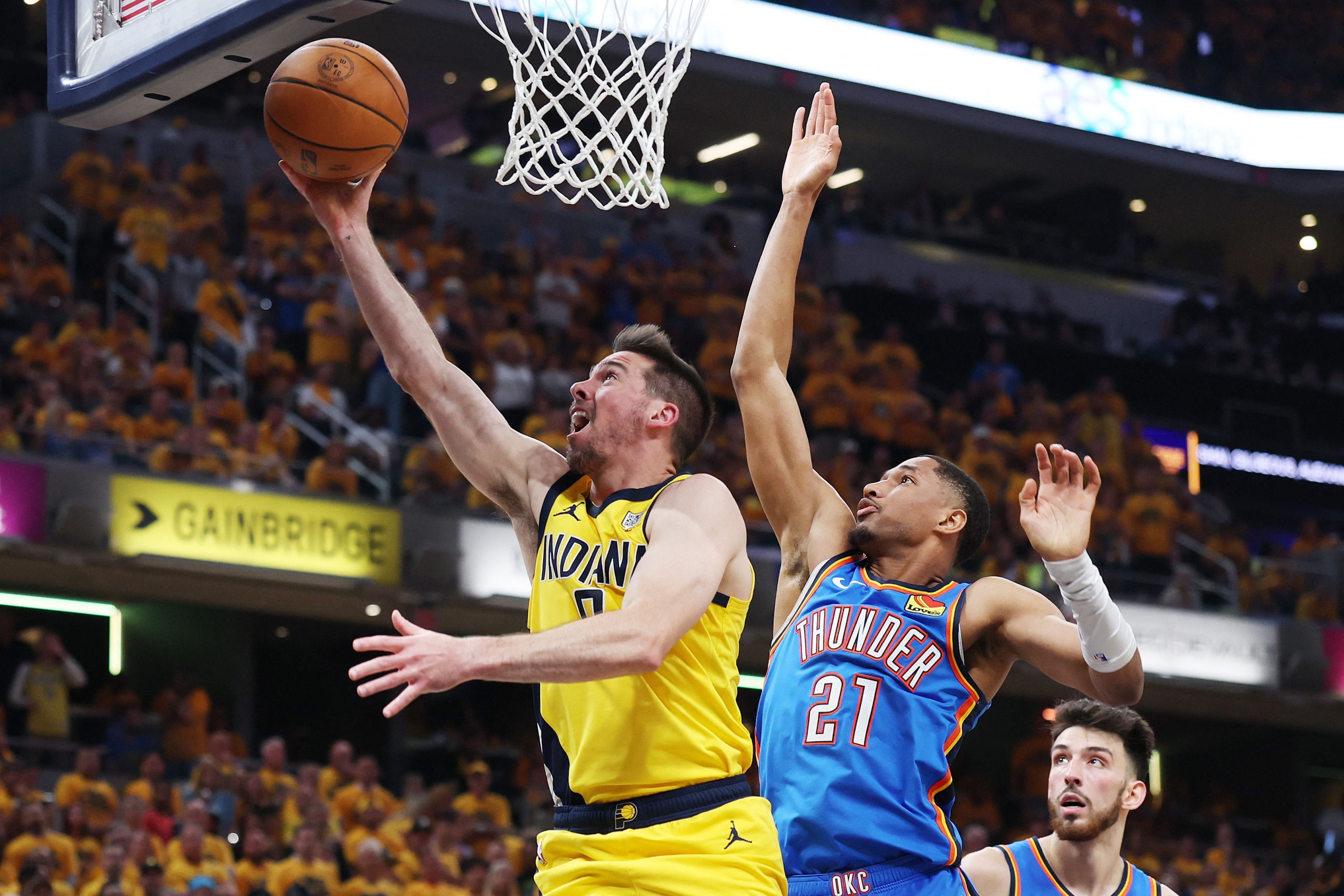 T.J. McConnell #9 of the Indiana Pacers attempts a layup against Aaron Wiggins #21 of the Oklahoma City Thunder during the second quarter in Game Six of the 2025 NBA Finals at Gainbridge Fieldhouse on June 19, 2025 in Indianapolis, Indiana. NOTE TO USER: User expressly acknowledges and agrees that, by downloading and or using this photograph, User is consenting to the terms and conditions of the Getty Images License Agreement. Maddie Meyer/Getty Images/AFP (Photo by Maddie Meyer / GETTY IMAGES NORTH AMERICA / Getty Images via AFP)
