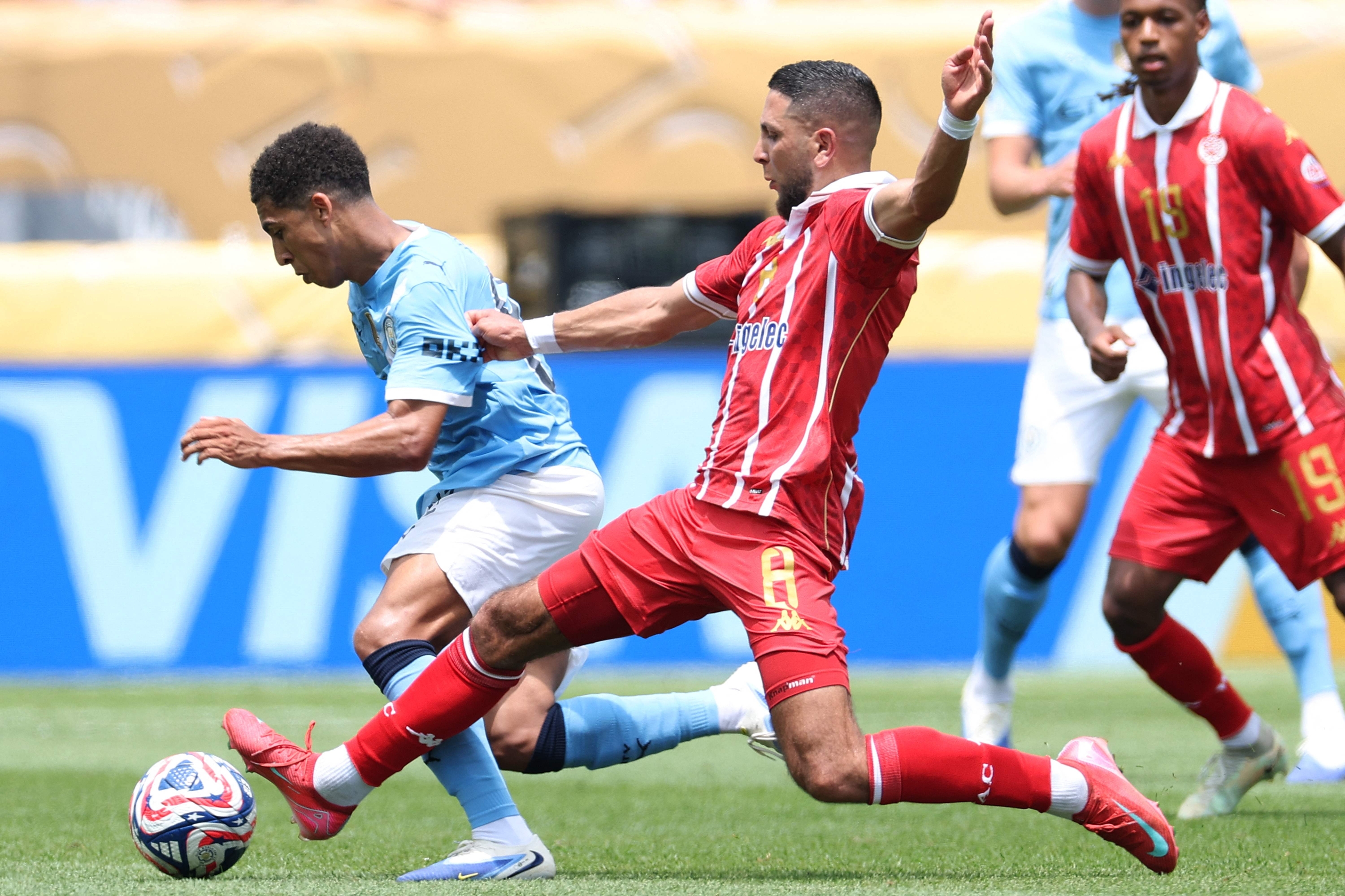 Manchester City's Brazilian midfielder #26 Savinho (L) fights for the ball with WAC Casablanca's Dutch forward #08 Mohamed Rayhi during the FIFA Club World Cup 2025 Group G football match between England's Manchester City and Morocco's Wydad AC at the Lincoln Financial Field stadium in Philadelphia on June 18, 2025. (Photo by CHARLY TRIBALLEAU / AFP)