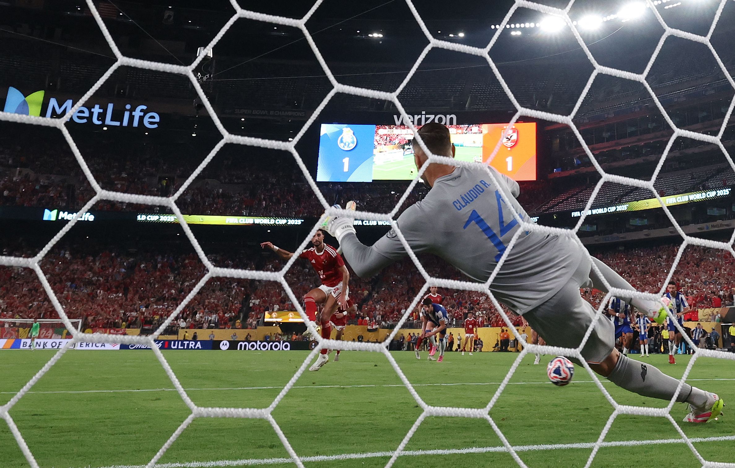 Al Ahly's Palestinian forward #09 Wessam Abou Ali scores his second goal from the penalty spot past FC Porto's Portuguese goalkeeper #14 Claudio Ramos during the FIFA Club World Cup 2025 Group A football match between Portugal's Porto FC and Egypt's Al-Ahly at the MetLife stadium in East Rutherford, New Jersey on June 23, 2025. (Photo by Franck FIFE / AFP)