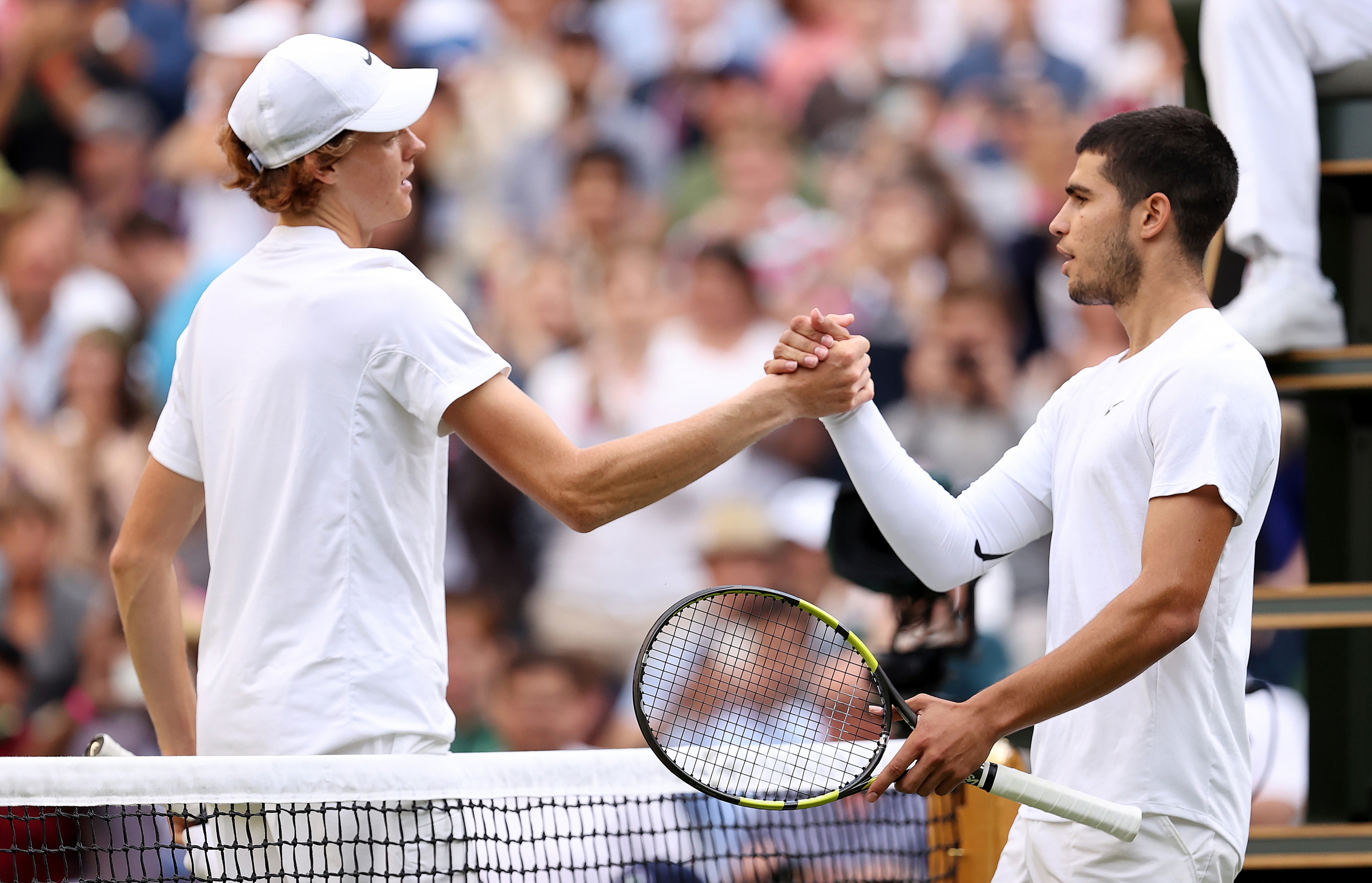 Jannik Sinner and Carlos Alcaraz interact at Wimbledon 2022