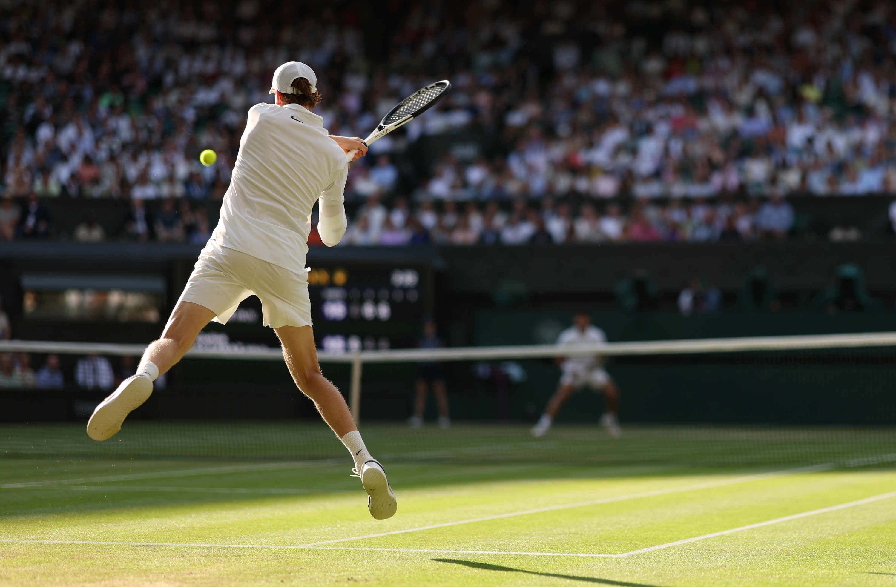 Jannik Sinner of Italy plays a backhand against Carlos Alcaraz of Spain during the Gentleman's Singles Final on day fourteen of The Championships Wimbledon 2025 at All England Lawn Tennis and Croquet Club on July 13, 2025 in London, England. (Photo by Clive Brunskill/Getty Images)