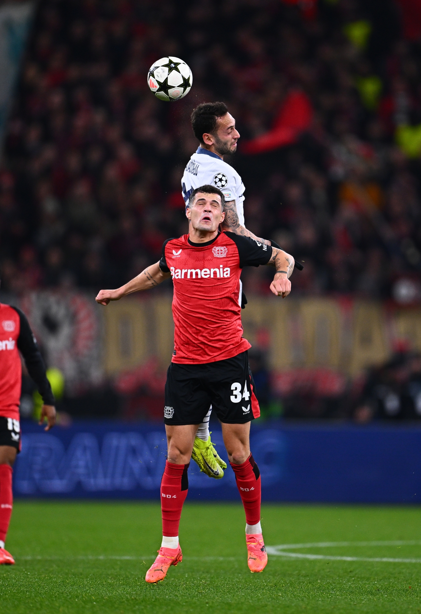 LEVERKUSEN, GERMANY - DECEMBER 10: Hakan Calhanoglu of FC Internazionale competes for the ball with Granit Xhaka of Bayer 04 Leverkusen during the UEFA Champions League 2024/25 League Phase MD6 match between Bayer 04 Leverkusen and FC Internazionale Milano at BayArena on December 10, 2024 in Leverkusen, Germany. (Photo by Mattia Ozbot - Inter/Inter via Getty Images)