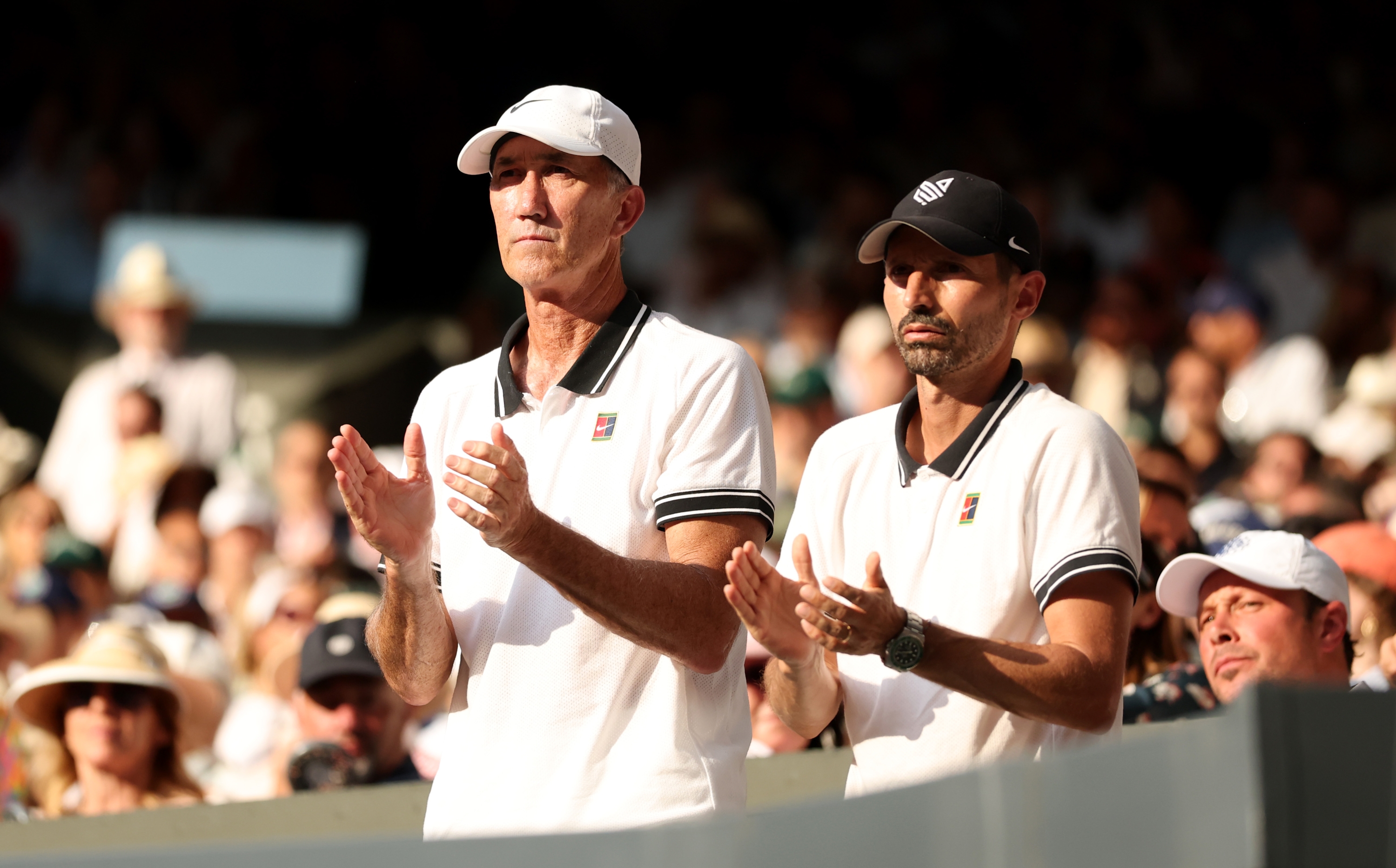 Darren Cahill and Simone Vagnozzi, Coaches of Jannik Sinner applaud from the player's box as Jannik Sinner of Italy plays against Carlos Alcaraz of Spain in the Gentleman's Singles Final on day fourteen of The Championships Wimbledon 2025 at All England Lawn Tennis and Croquet Club on July 13, 2025 in London, England. (Photo by Clive Brunskill/Getty Images)