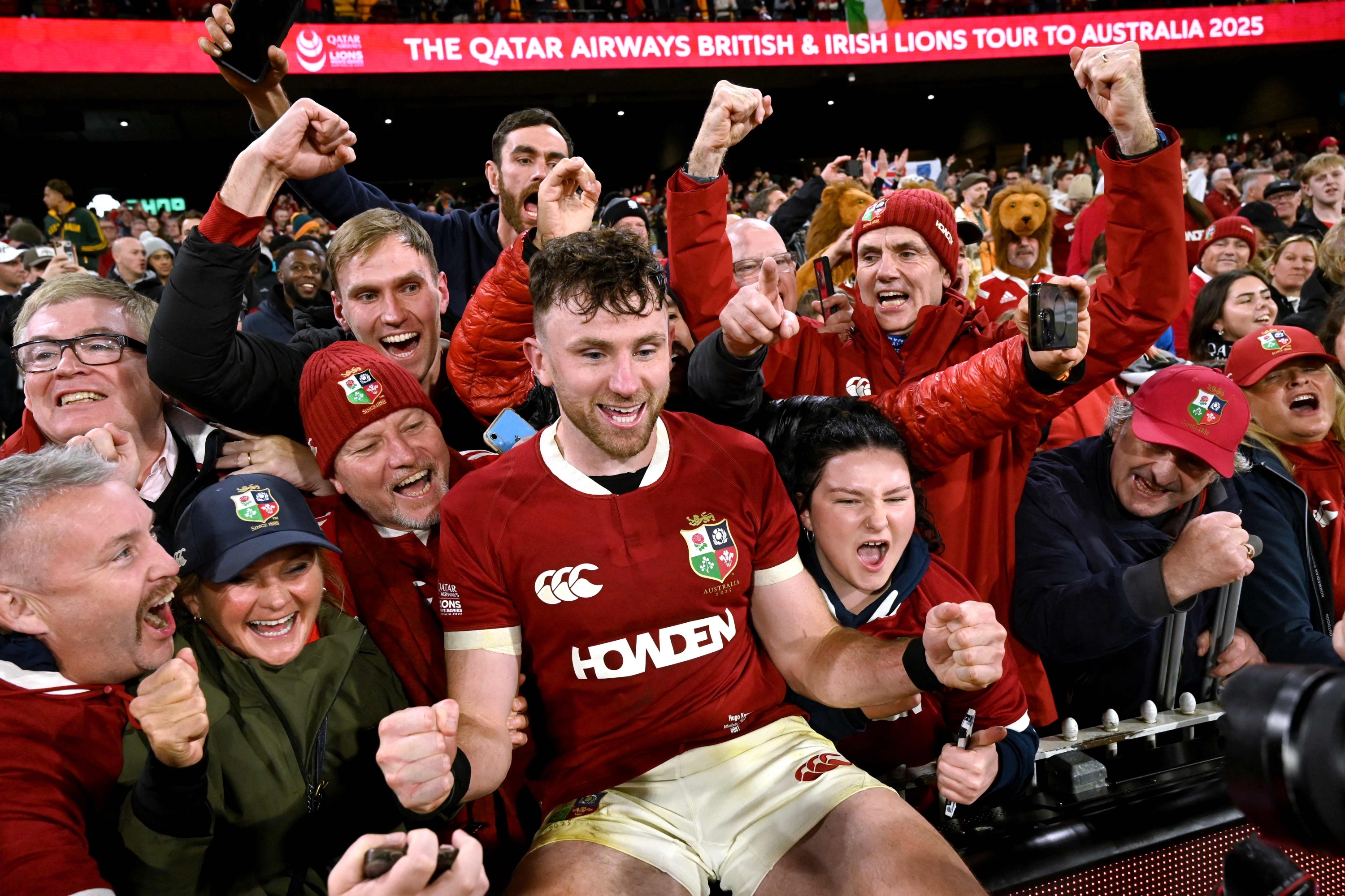 British and Irish Lions’ Hugo Keenan (C) celebrates with supporters after the second rugby Test match against Australia at the Melbourne Cricket Ground (MCG) on July 26, 2025. (Photo by WILLIAM WEST / AFP) / -- IMAGE RESTRICTED TO EDITORIAL USE - STRICTLY NO COMMERCIAL USE —