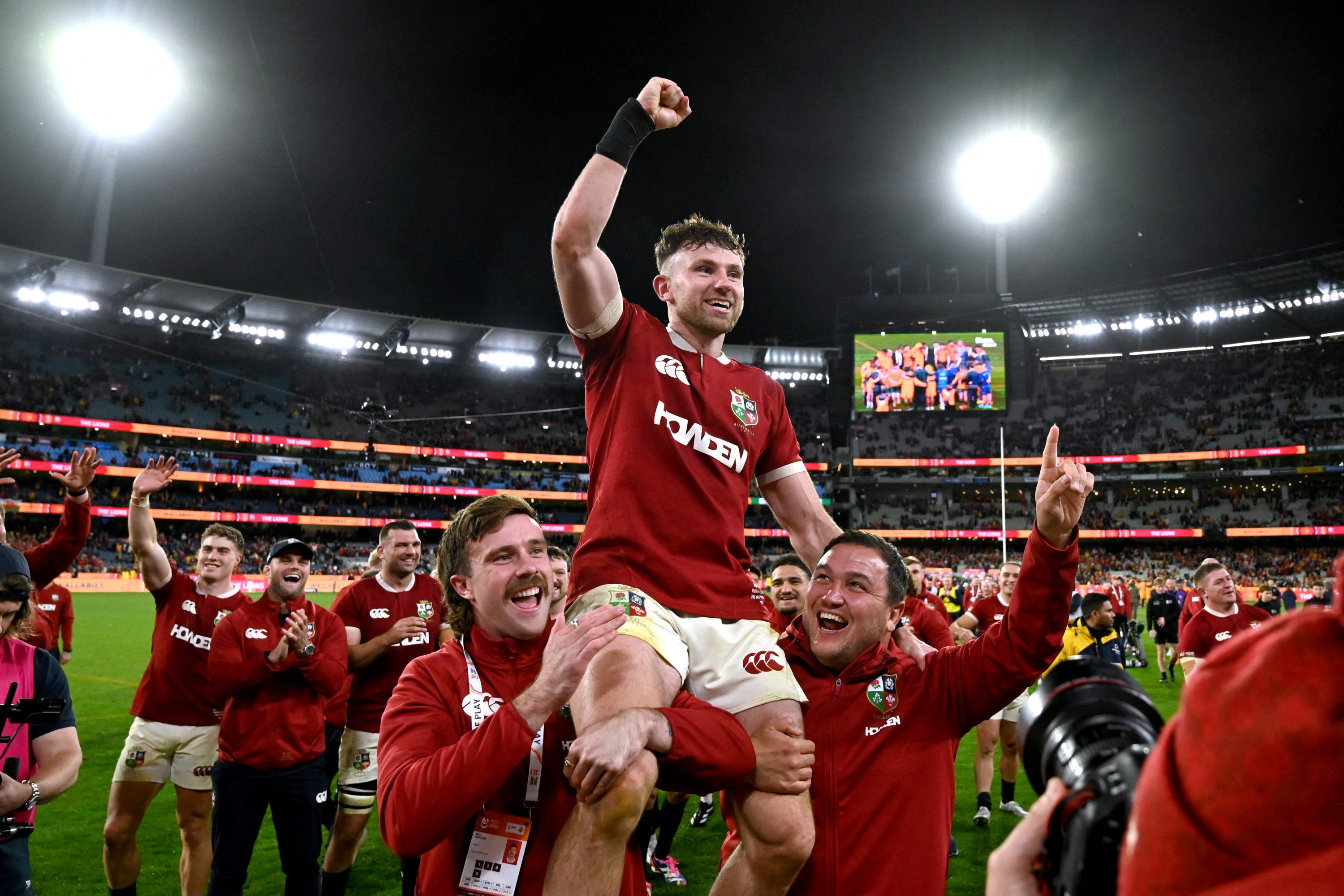 British and Irish Lions’ Hugo Keenan (C) celebrates with team mates after the second rugby Test match against Australia at the Melbourne Cricket Ground (MCG) on July 26, 2025. (Photo by WILLIAM WEST / AFP) / -- IMAGE RESTRICTED TO EDITORIAL USE - STRICTLY NO COMMERCIAL USE —