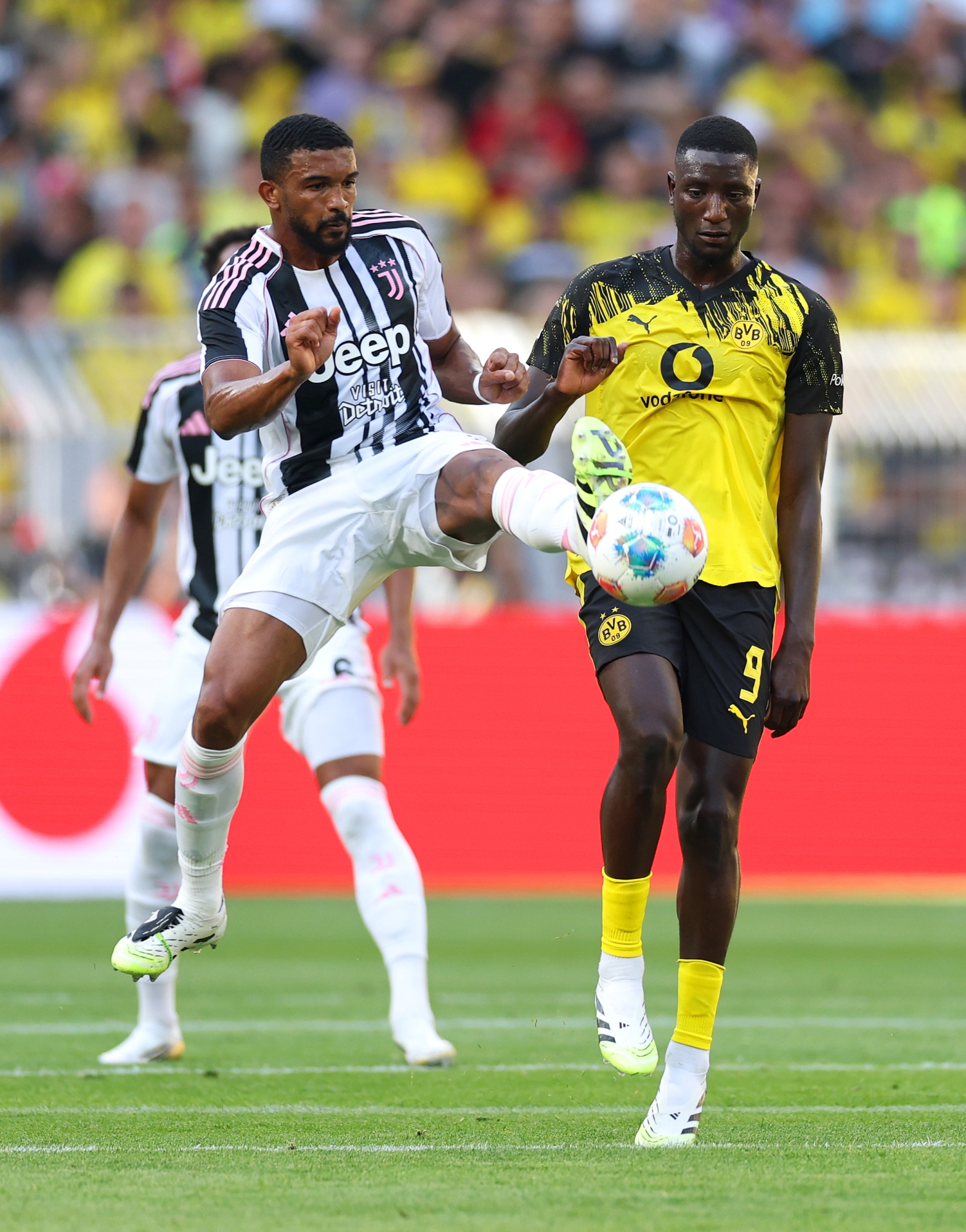 DORTMUND, GERMANY - AUGUST 10: Bremer of Juventus is challenged by Serhou Guirassy of Borussia Dortmund during the pre-season friendly match between Borussia Dortmund and Juventus FC at Signal Iduna Park on August 10, 2025 in Dortmund, Germany. (Photo by Lars Baron/Getty Images)