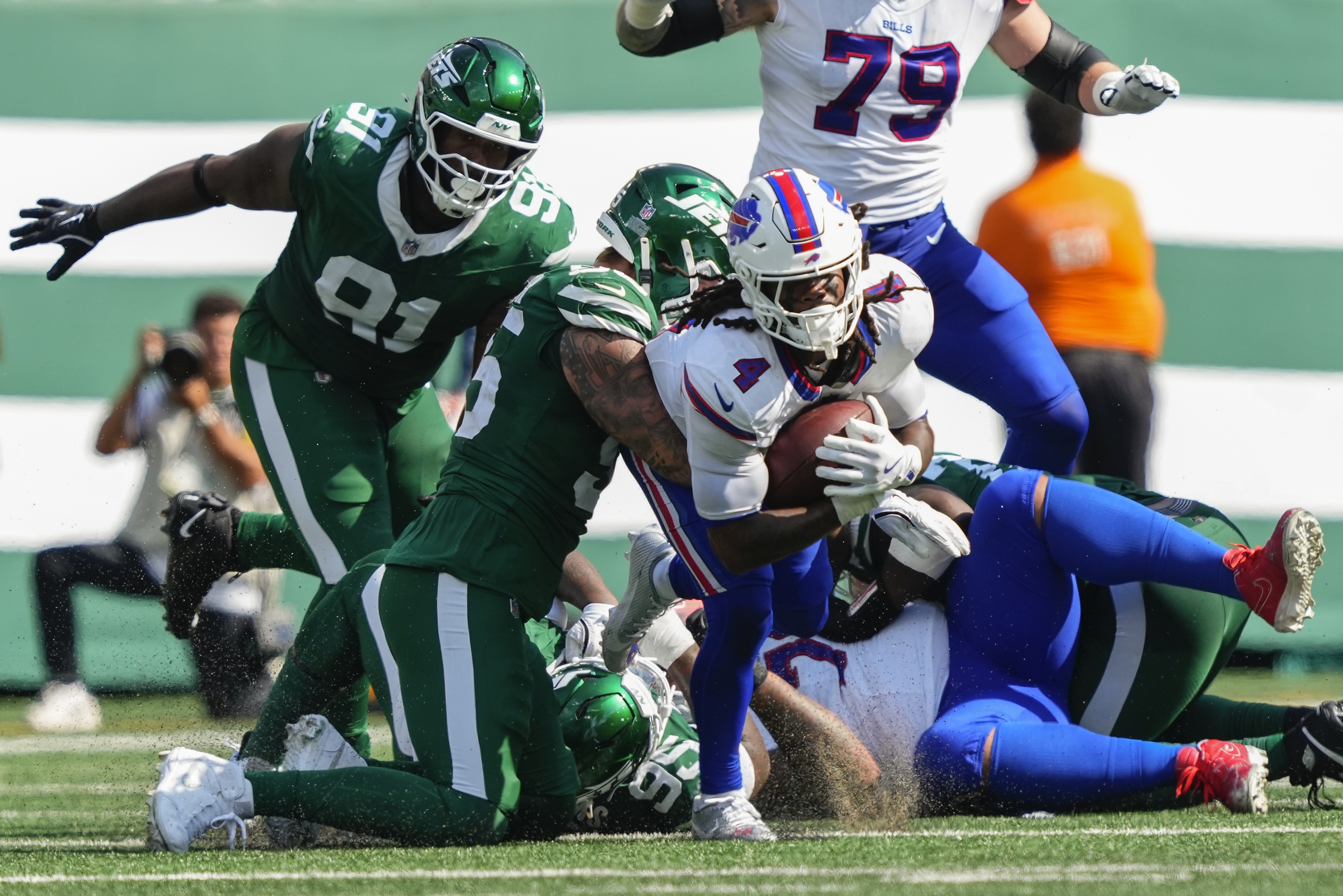 Buffalo Bills running back James Cook (4) is tackled by New York Jets defensive end Braiden McGregor (55) during the third quarter of an NFL football game, Sunday, Sept. 14, 2025, in East Rutherford, N.J. (AP Photo/Yuki Iwamura)
