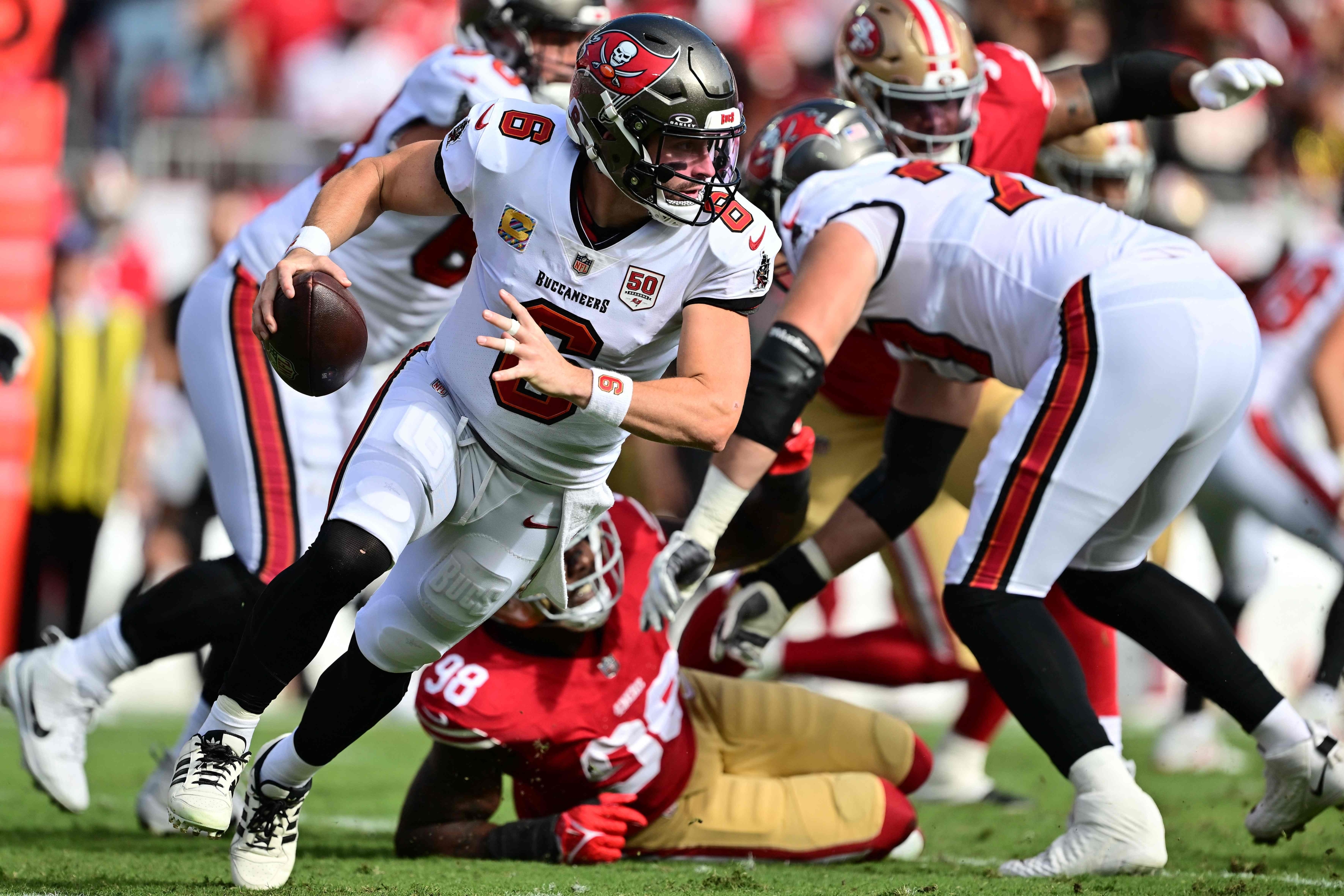 Baker Mayfield #6 of the Tampa Bay Buccaneers carries the ball against the San Francisco 49ers during the first quarter in the game at Raymond James Stadium on October 12, 2025 in Tampa, Florida. Julio Aguilar/Getty Images/AFP (Photo by Julio Aguilar / GETTY IMAGES NORTH AMERICA / Getty Images via AFP)
