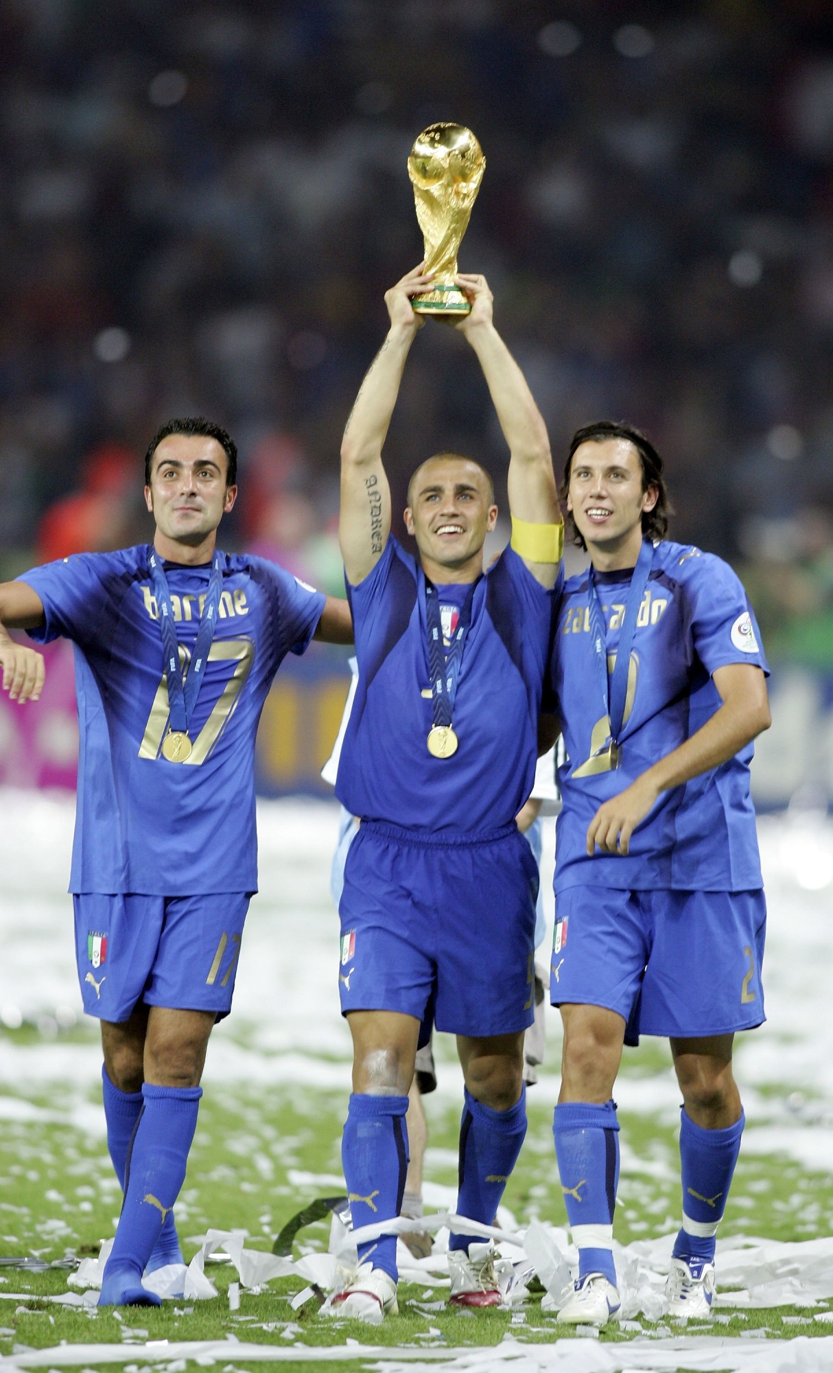 (L to R) Simone Barone, Fabio Cannavaro and Cristian Zaccardo of Italy celebrate with the world cup trophy after the FIFA World Cup Germany 2006 Final match between Italy and France at the Olympic Stadium on July 9, 2006 in Berlin, Germany.
(Photo by Ben Radford/Getty Images)