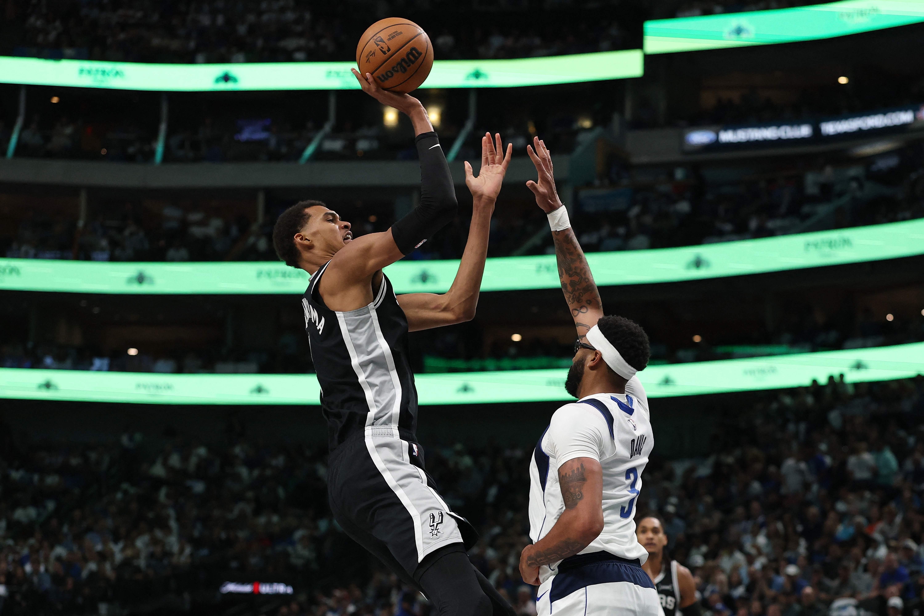 Victor Wembanyama #1 of the San Antonio Spurs shoots over Anthony Davis #3 of the Dallas Mavericks during the first half at American Airlines Center on October 22, 2025 in Dallas, Texas. NOTE TO USER: User expressly acknowledges and agrees that, by downloading and or using this photograph, User is consenting to the terms and conditions of the Getty Images License Agreement. Stacy Revere/Getty Images/AFP (Photo by Stacy Revere / GETTY IMAGES NORTH AMERICA / Getty Images via AFP)