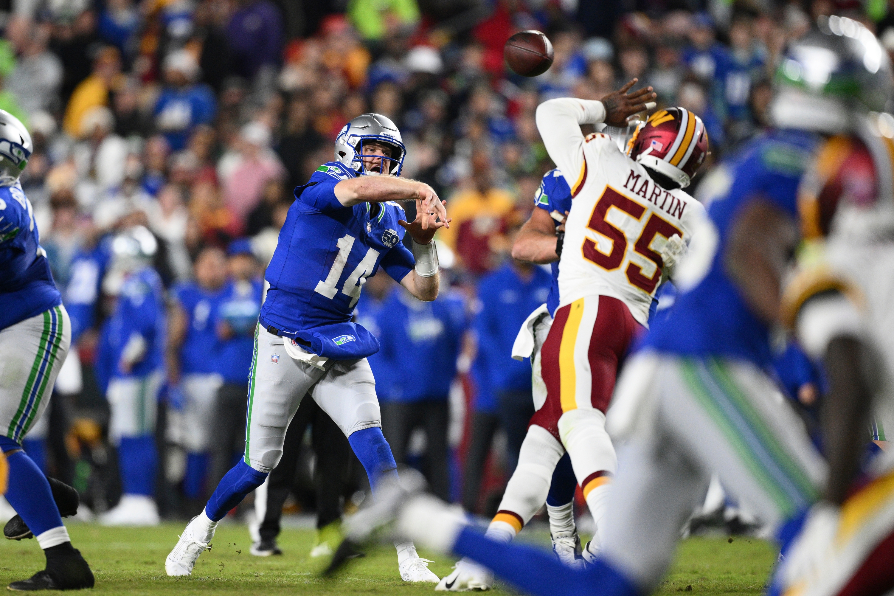 Seattle Seahawks quarterback Sam Darnold (14) pass the ball under pressure during the second half of an NFL football game against the Washington Commanders, Sunday, Nov. 2, 2025, in Landover, Md. (AP Photo/Nick Wass)