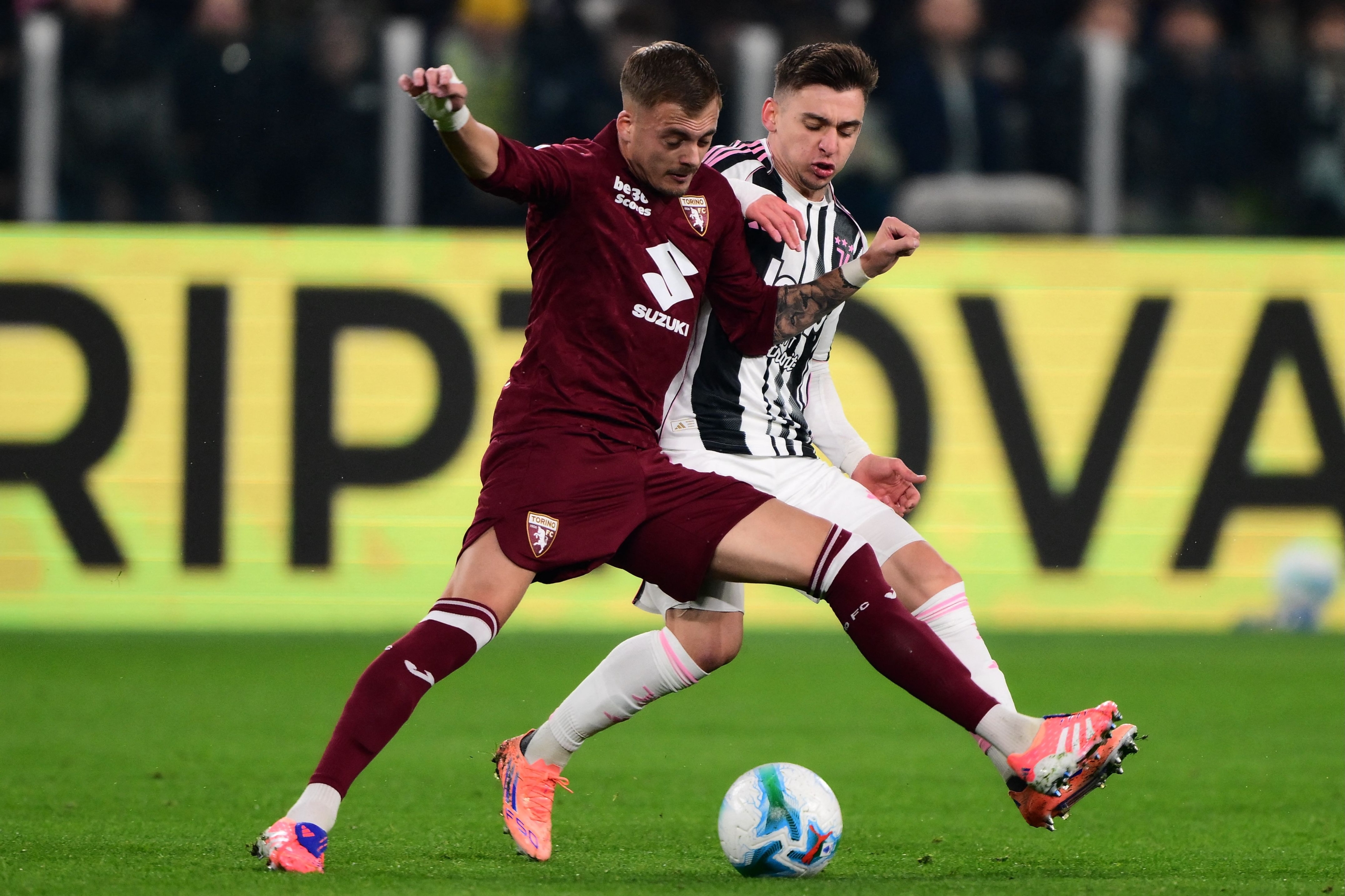 Torino&#146;s Serbian midfielder #8 Ivan Ilic fights for the ball with Juventus Portuguese forward #7 Francisco Conceicao (R) during the Italian Serie A football match between Juventus and Torino at the Allianz Stadium in Turin on November 8, 2025. (Photo by MARCO BERTORELLO / AFP)
