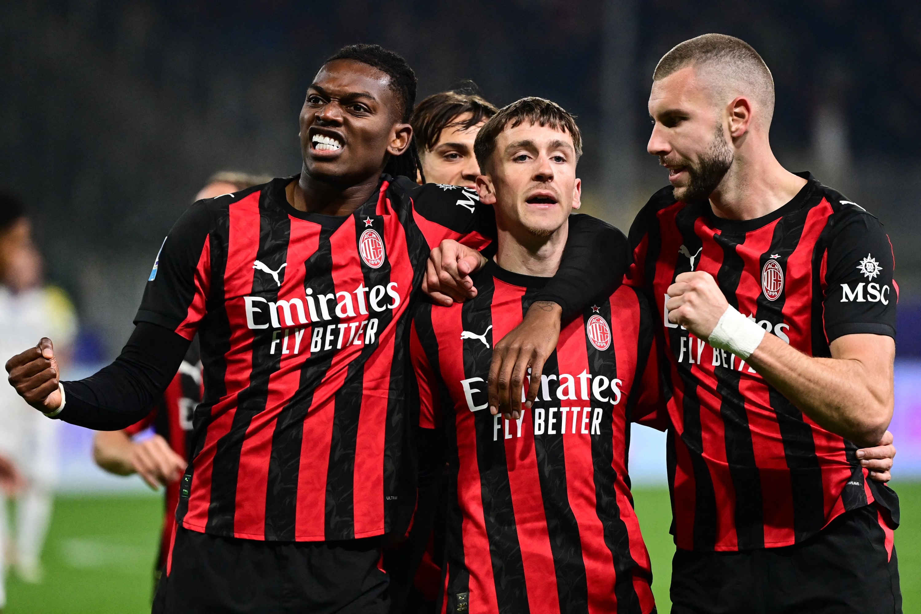 AC Milan's Belgian midfielder #56 Alexis Saelemaekers (C) celebrates after scoring his team first goal with AC Milan's Serbian defender #31 Strahinja Pavlovic (R) and AC Milan's Portuguese forward #10 Rafael Leao (L) during the Italian Serie A football match between Parma and AC Milan at the San Siro Stadium in Parma, northern Italy, on November 8, 2025. (Photo by Piero CRUCIATTI / AFP)