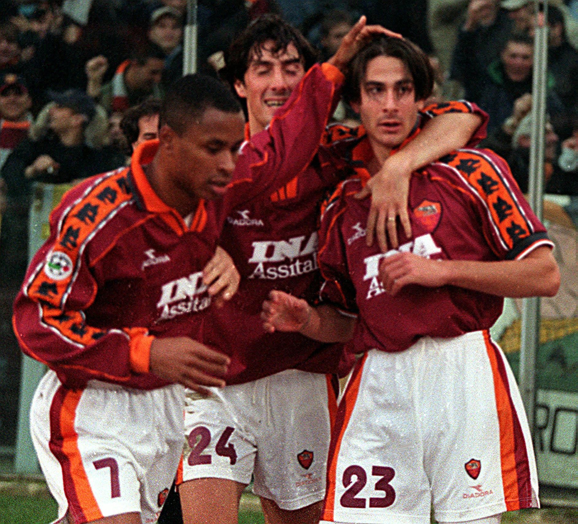 AS Roma's Daniele Conti, right, is cheered by his teammates Paolo Sergio of Brazil, left, and Marco Del Vecchio after scoring AS Roma's second goal during the Italian first division soccer match AS Roma vs Perugia in Rome's Olympic stadium, Saturday, December 5,1998. Rome won 5-1. (AP Photo/Giuseppe Calzuola)