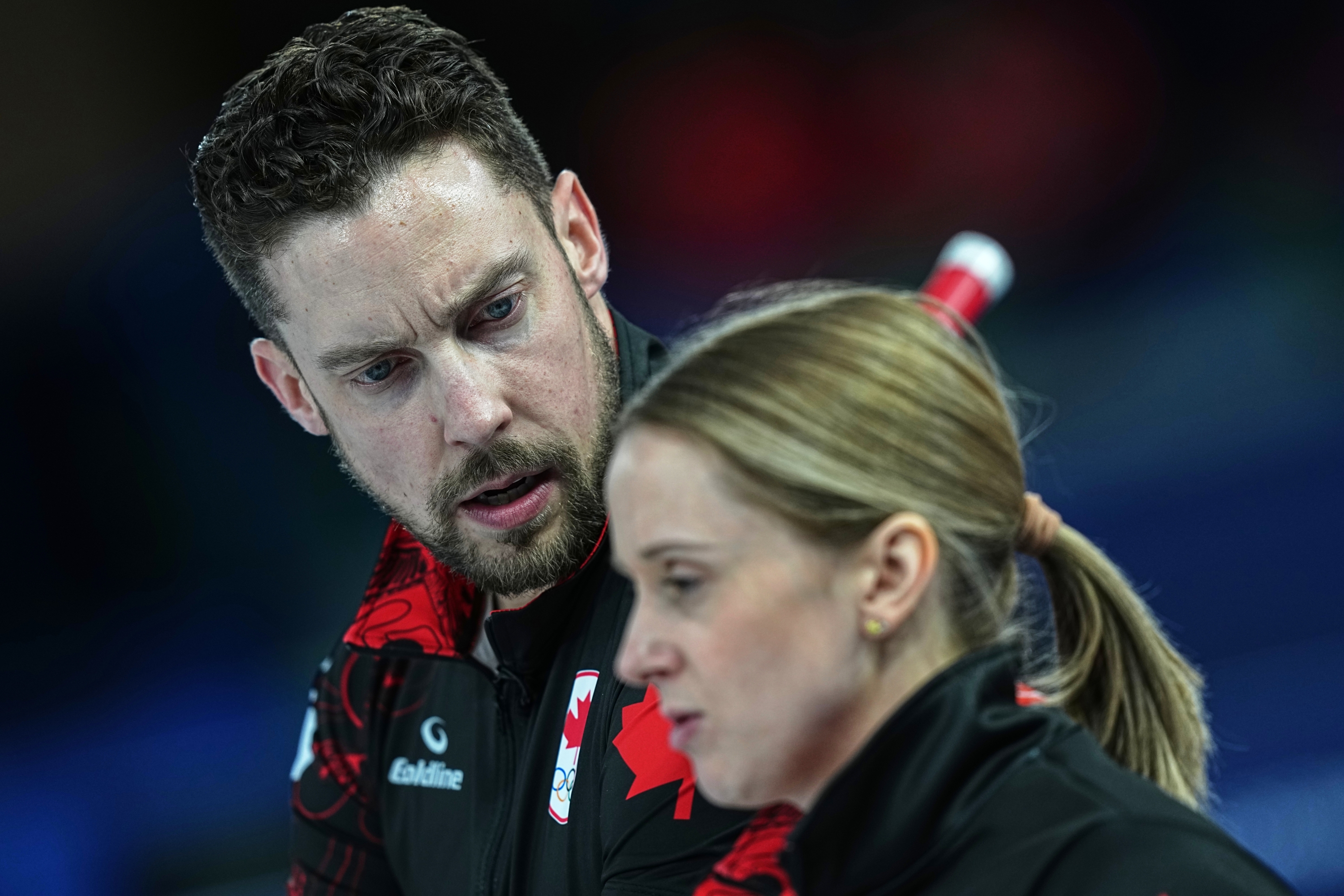 Canada's Brett Gallant and Jocelyn Peterman speak,during the mixed doubles round robin phase of the curling competition against Sweden, at the 2026 Winter Olympics, in Cortina d'Ampezzo, Italy, Sunday, Feb. 8, 2026. (AP Photo/Fatima Shbair)