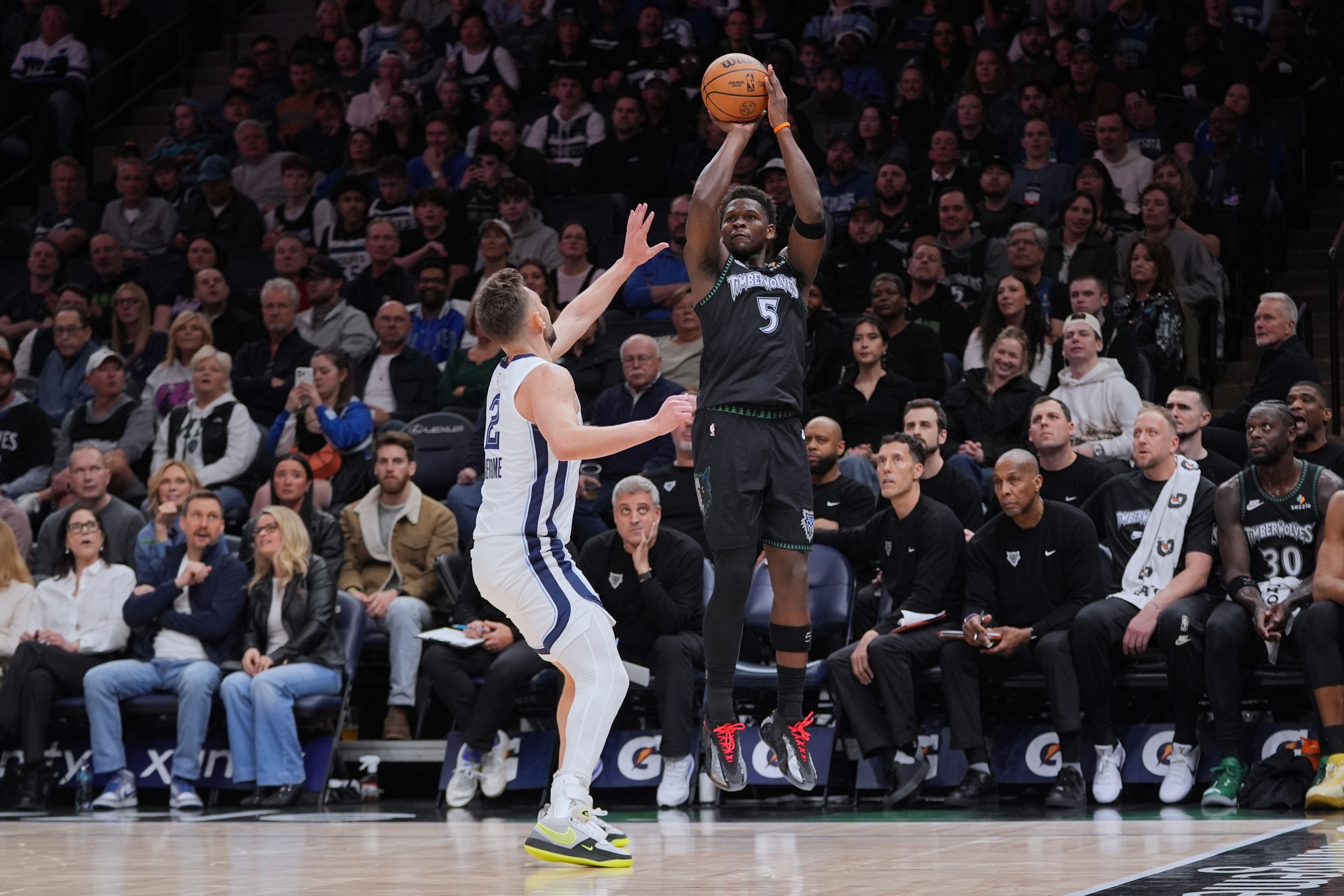 Minnesota Timberwolves guard Anthony Edwards (5) shoots over Memphis Grizzlies guard Ty Jerome (2) during the first half of an NBA basketball game, Tuesday, March 3, 2026, in Minneapolis. (AP Photo/Abbie Parr)