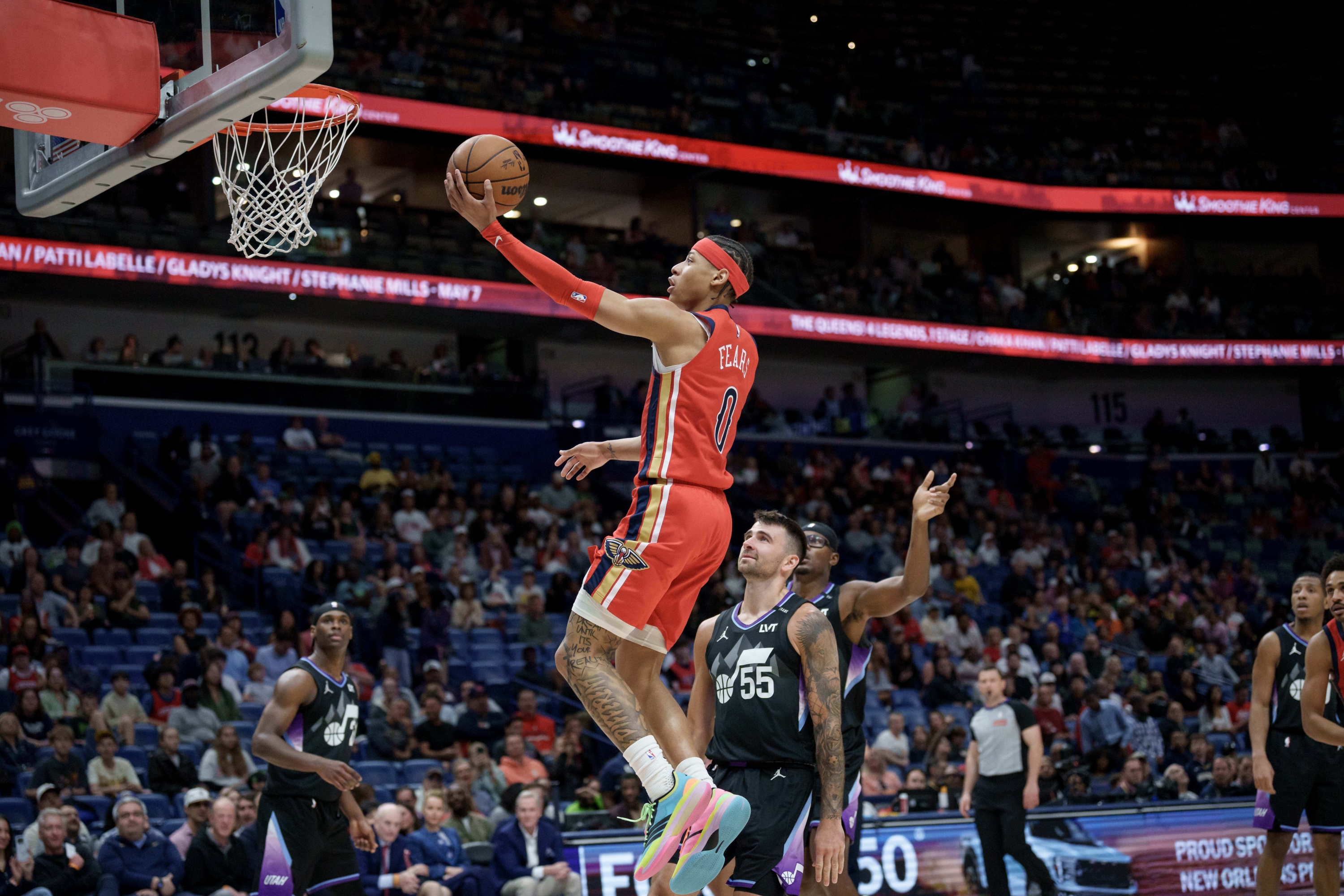 New Orleans Pelicans guard Jeremiah Fears (0) shoots against Utah Jazz guard John Konchar (55) during the second half of an NBA basketball game in New Orleans, Tuesday, April 7, 2026. (AP Photo/Matthew Hinton)