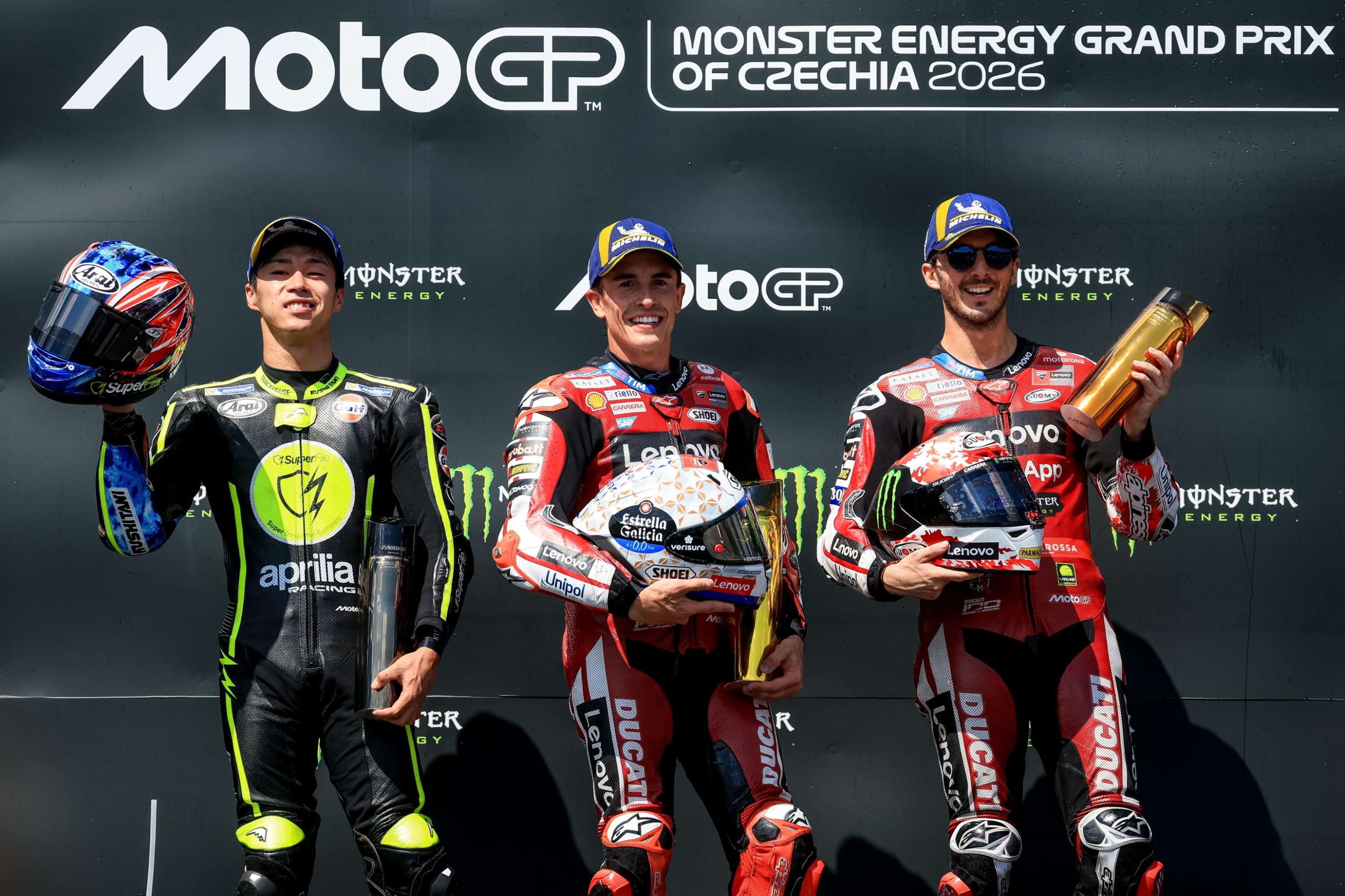 epa13054021 (L-R) Second placed Japanese MotoGP rider Ai Ogura of Trackhouse MotoGP Team, winner Spanish MotoGP rider Marc Marquez of Ducati Lenovo Team and third placed Italian MotoGP rider Francesco Bagnaia of Ducati Lenovo Team pose on podium after the Motorcycling Grand Prix of the Czech Republic at the Masaryk Circuit in Brno, Czech Republic, 21 June 2026.  EPA/MARTIN DIVISEK